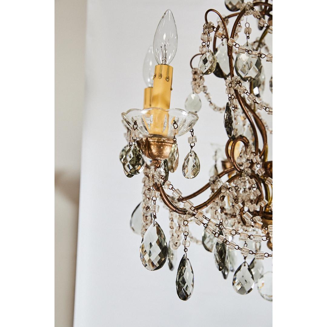 French six light crystal chandelier
8,500.00
This elegant Louis XV style gilt chandelier has crystal beads and pendants throughout. The piece has six lights with candle covers and French wiring. The larger drop crystals are a smokey grey color.
