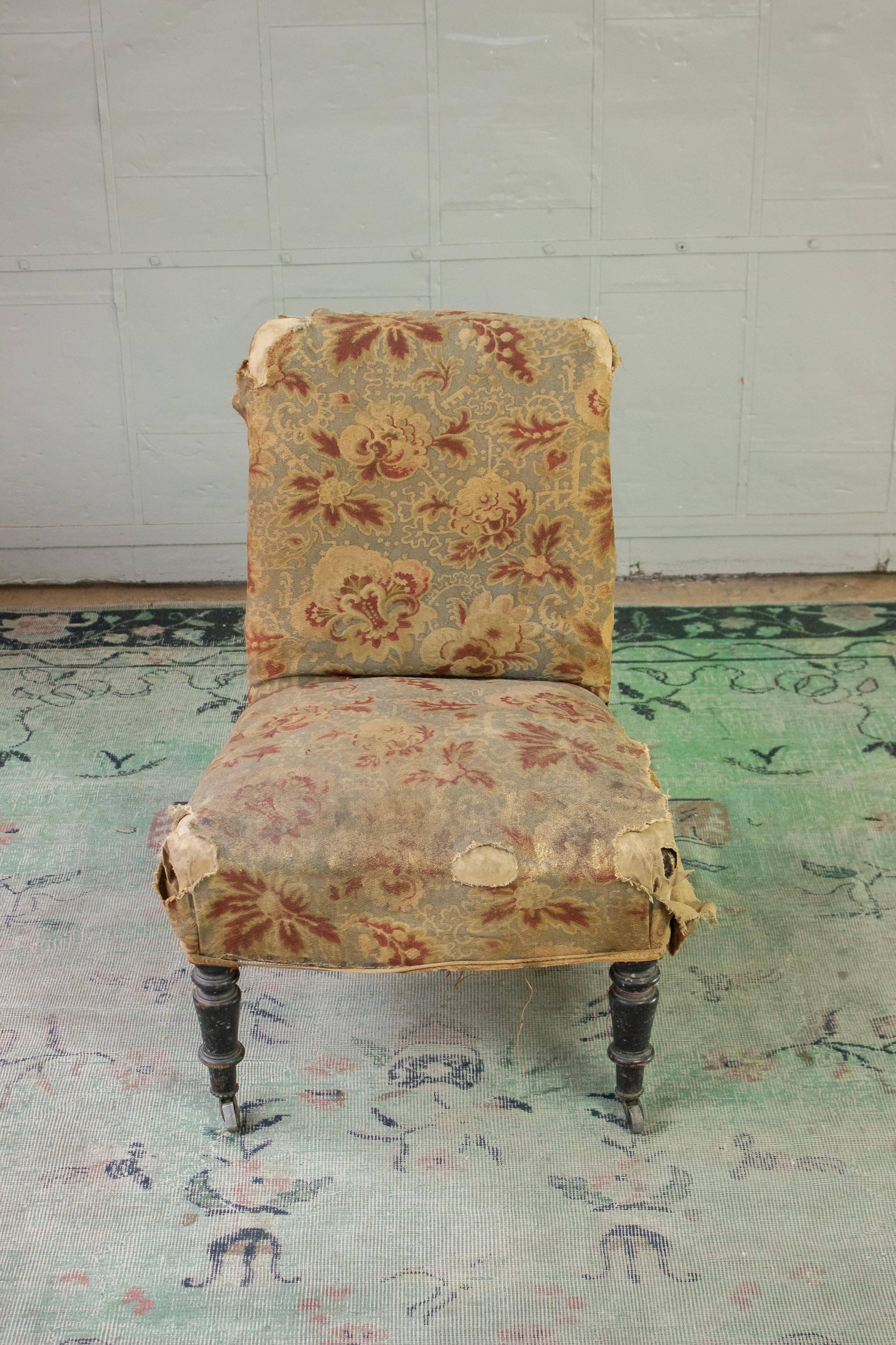 Petite French 19th century slipper chair with distressed fabric.

Upholstery and refinishing options are available.