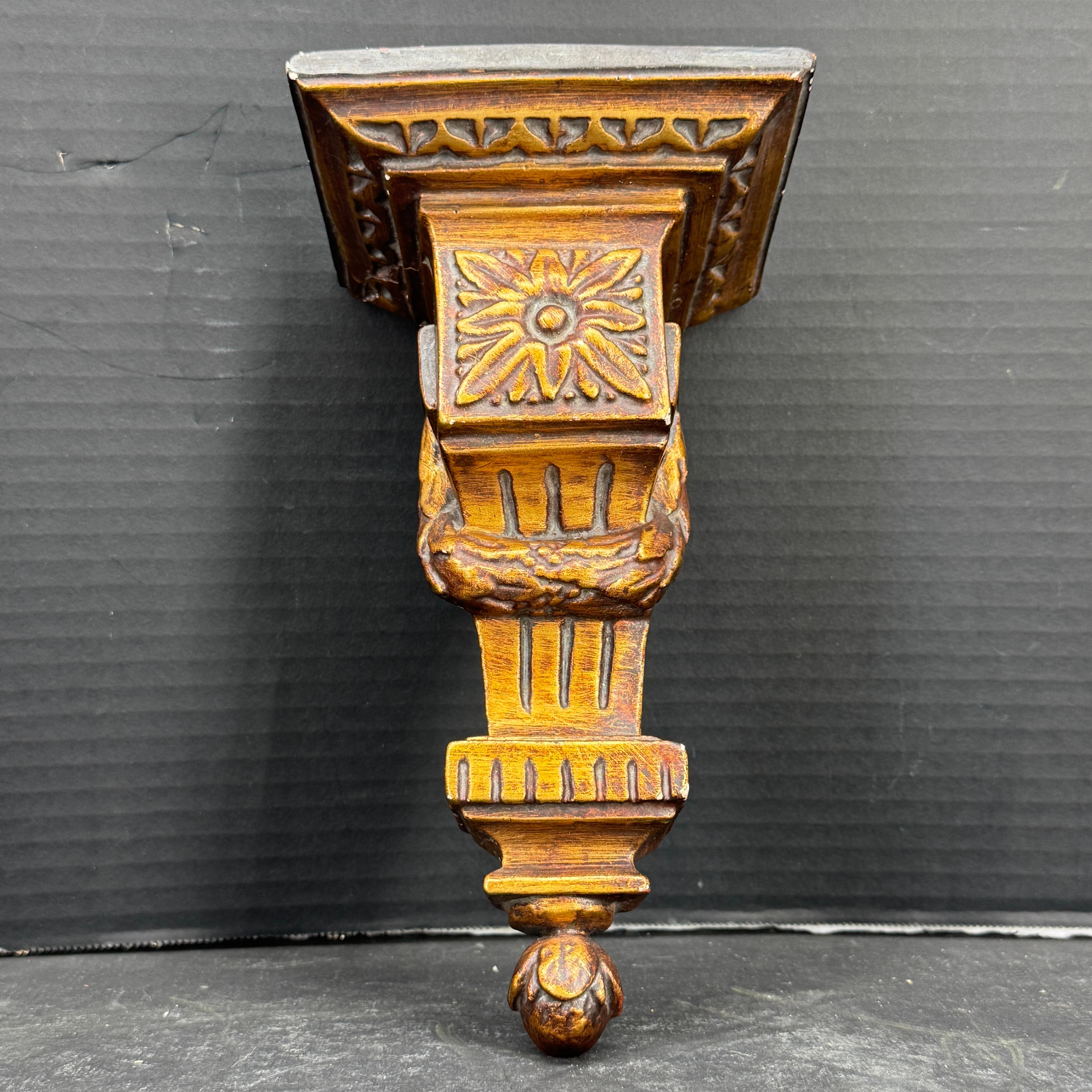 As found in a French market, this ceramic gilded wall corbel or shelf is beautifully constructed and ornamented with a floral ornament in the center. This Louis XVI gilt piece would be a wonderful architectural element standing alone or on any wall
