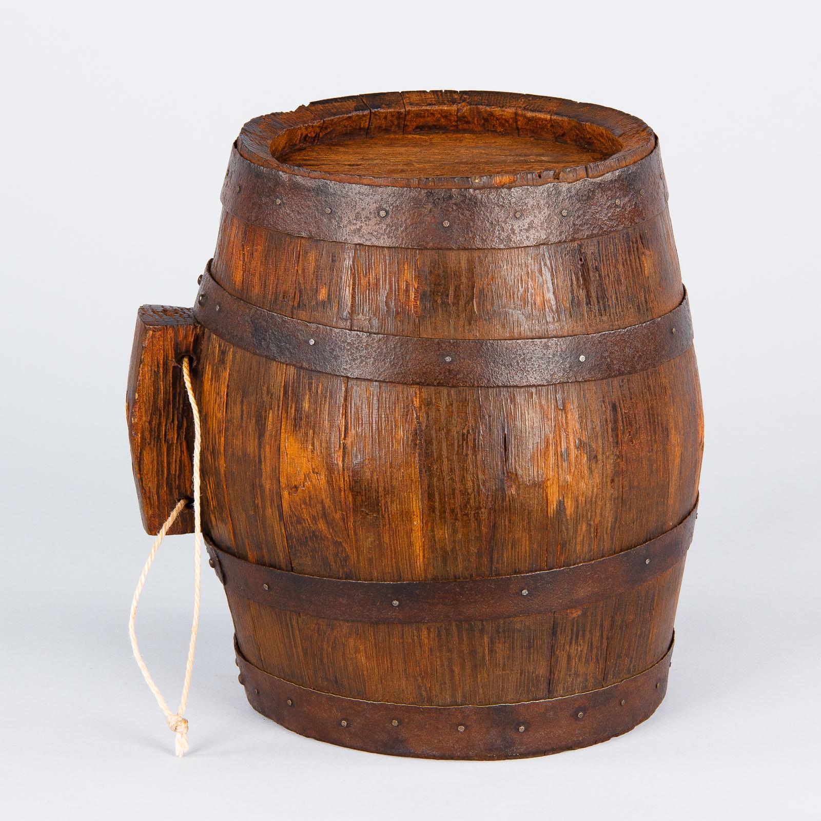 A handsome small oak wine barrel from Provence with nailed iron straps. A very decorative piece for the kitchen or the wine room. The rope was added later to hang barrel. The original cork is missing.