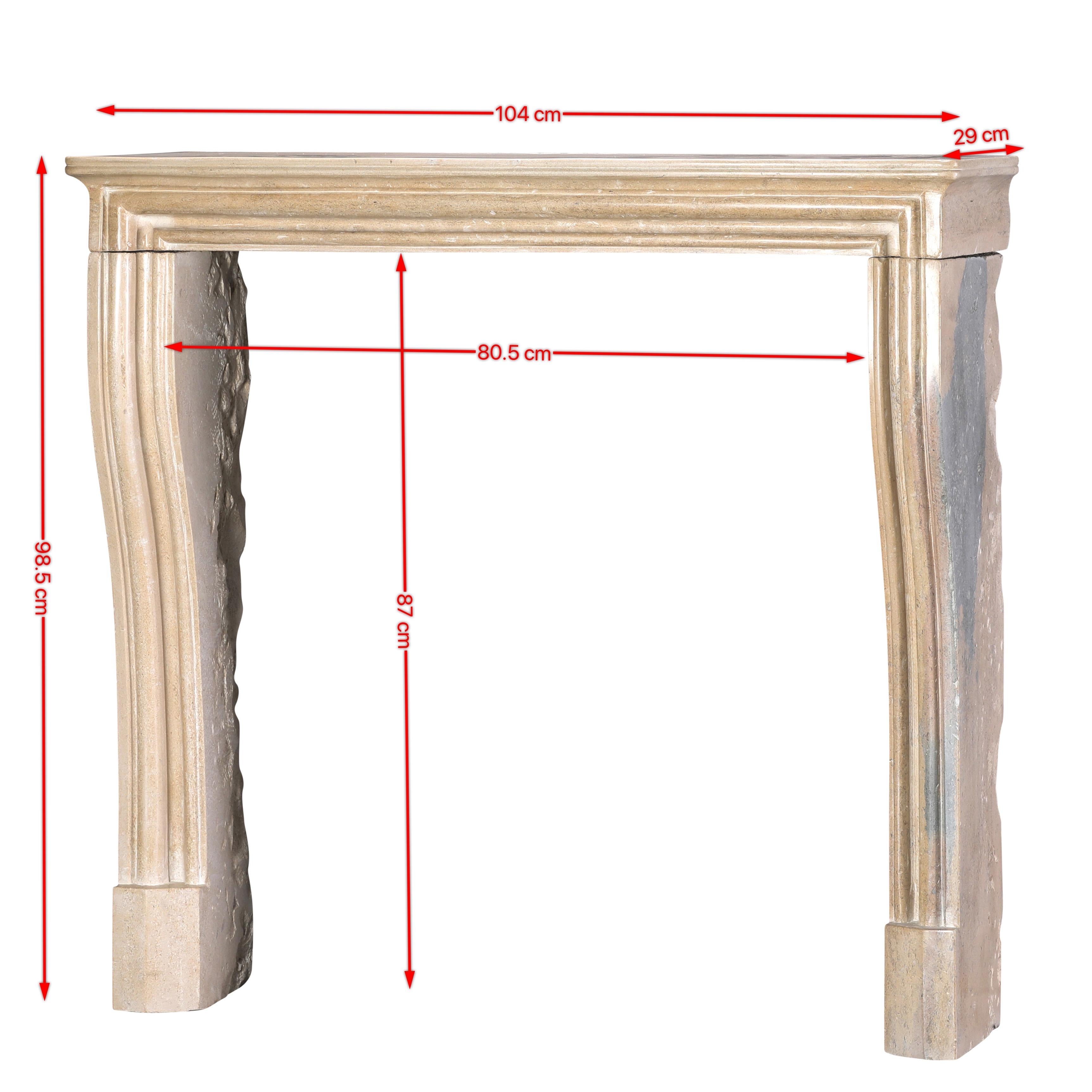 This authentic 19th century French timeless Louis XIV style petite fireplace surround is handcrafted from hard beige limestone from the Burgundy region.
Featuring refined mouldings, elegant curves, and superb surface patina with subtle blue-grey