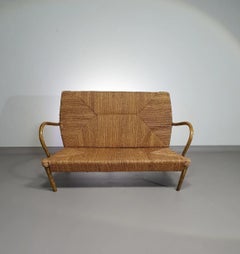 French sofa /  A metal frame base, bentwood armrests and a papercord seating