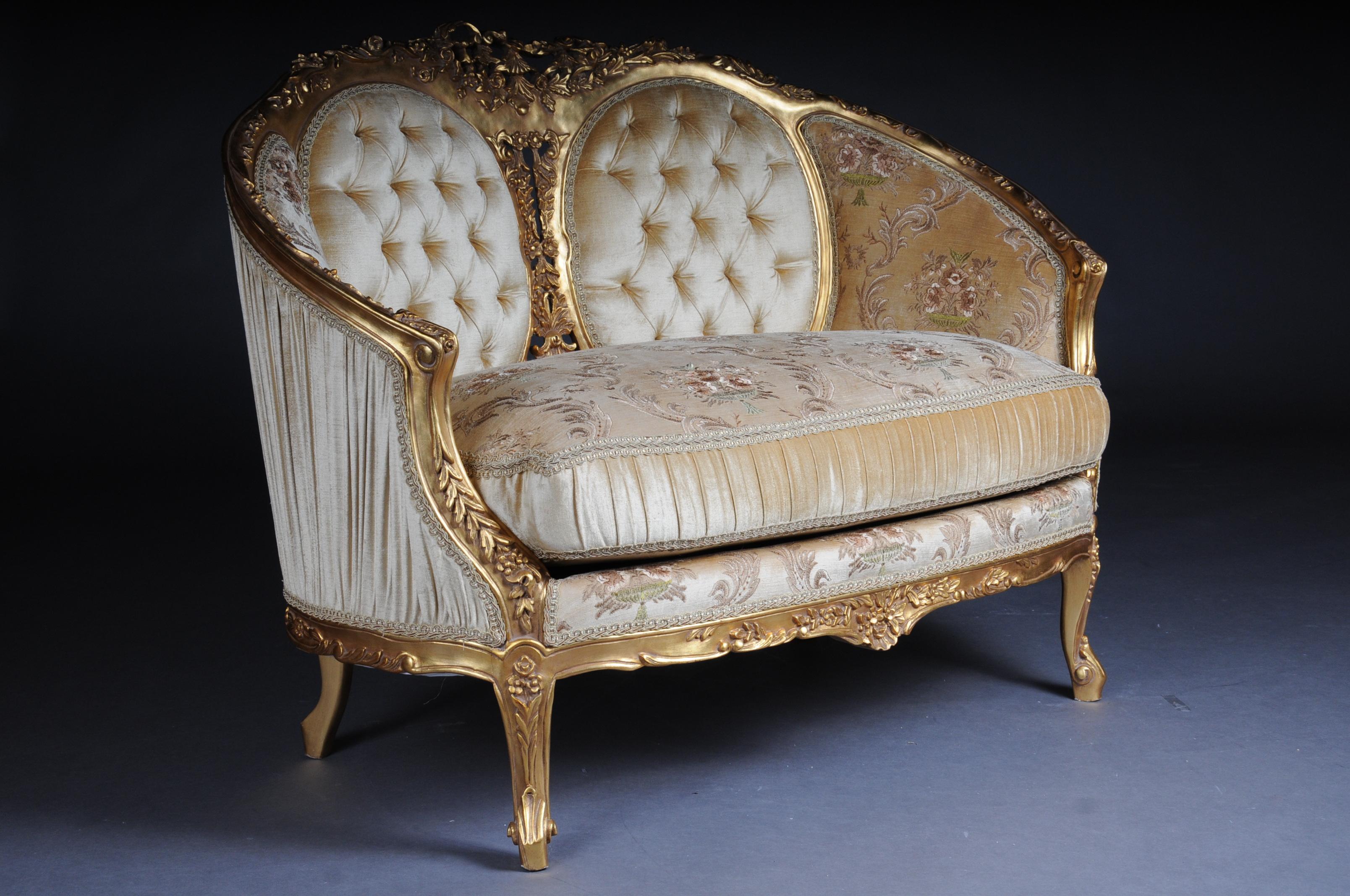 French sofa, canapé, couch in Rococo or Louis XV style.

Solid beech wood, carved and gilded. Semicircular rising backrest framing with openwork rocaille crowning. Appropriately curved frame with richly carved foliage. Slightly curved frame on