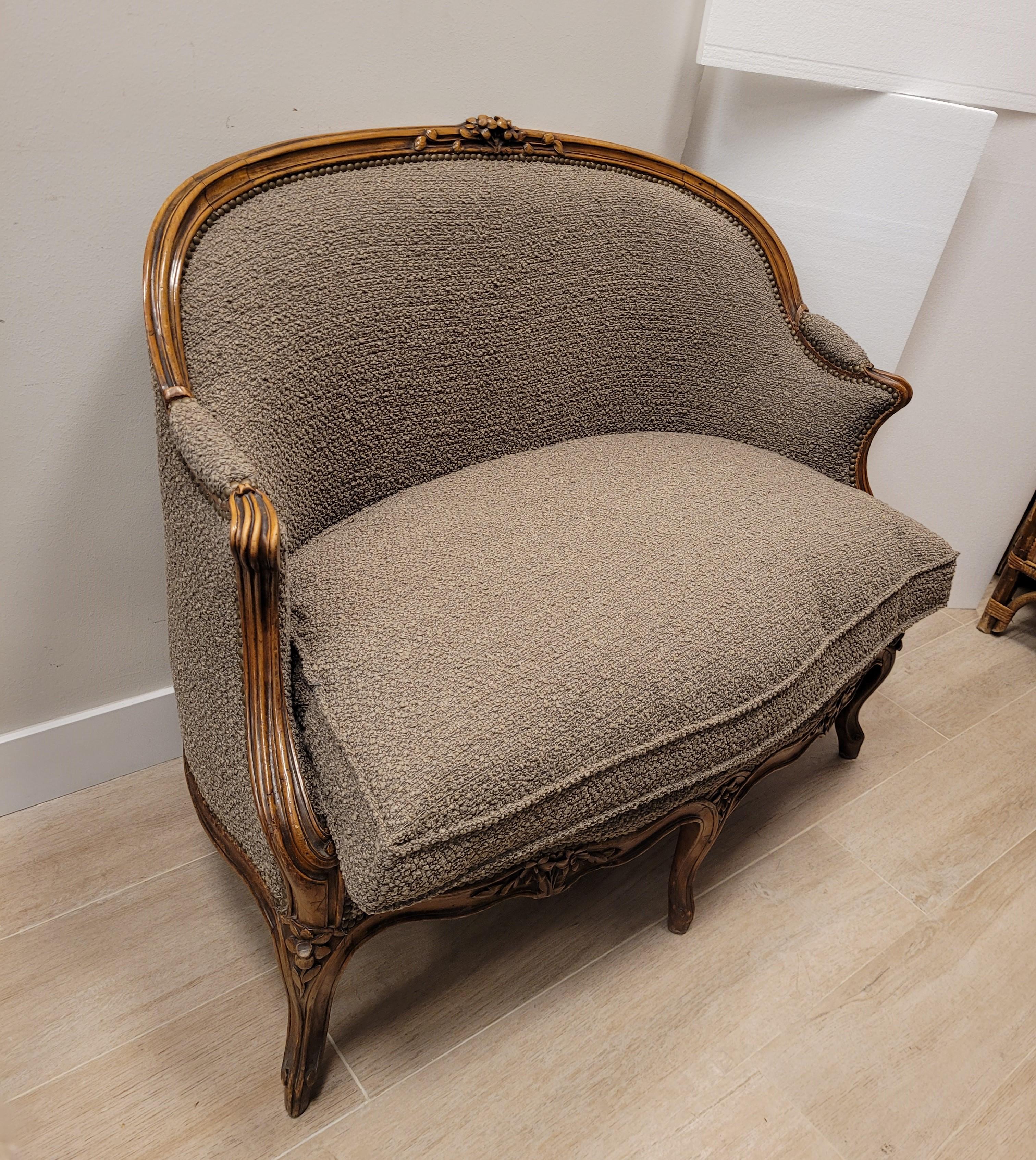 Gorgeous Canapé- sofá en Corbeille, in Louis XV style, made of carved walnut wood with plant decorations and 19th century , recently  re-upholstery in mink color loop wool or wool bouclé. The Corbeille settee is a type of settee with an oval base,