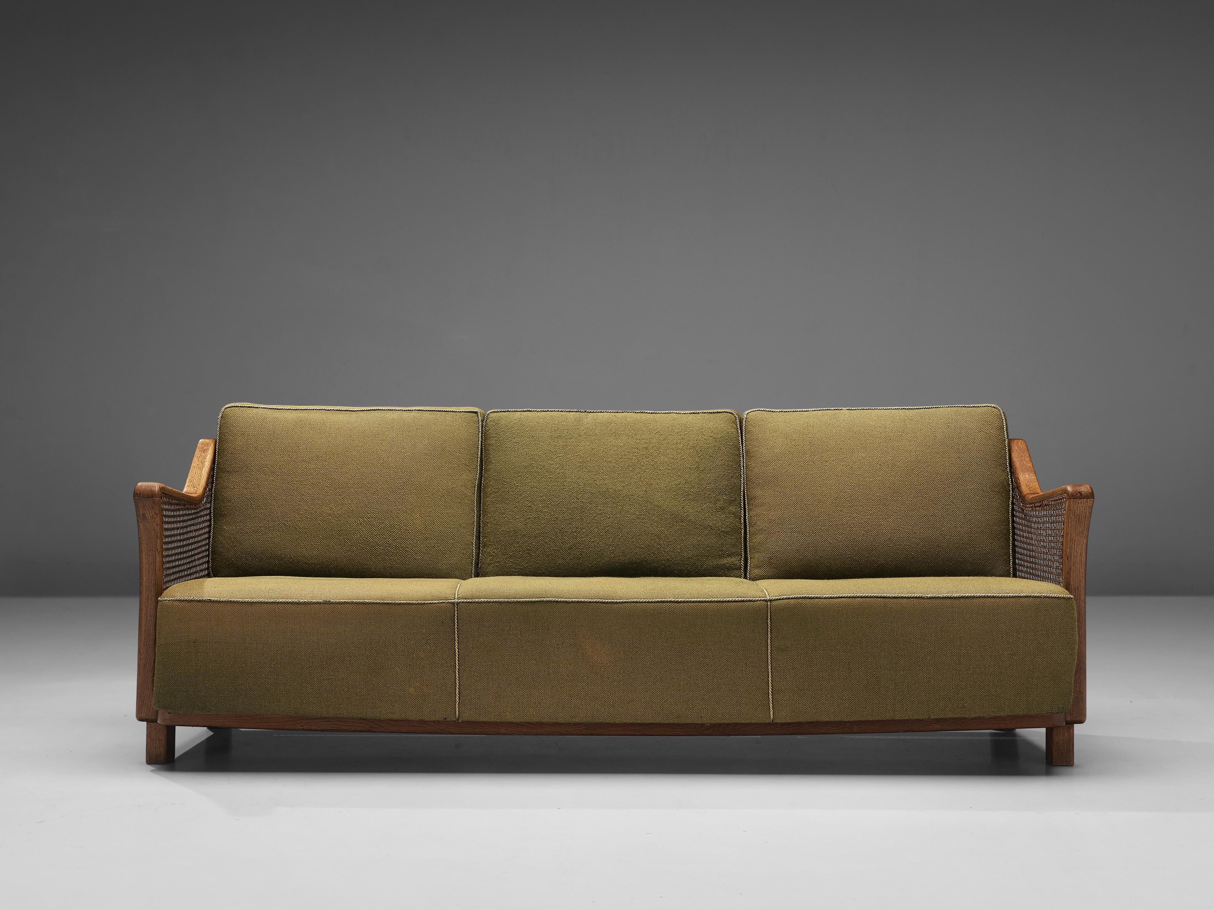 Sofa, cane and oak, France, 1960s

The design of this stunning sofa features beautiful, clear lines, contributing to a sculptural appearance. The frame of the slightly titled backrest and armrests are executed in rattan. The structure, on the