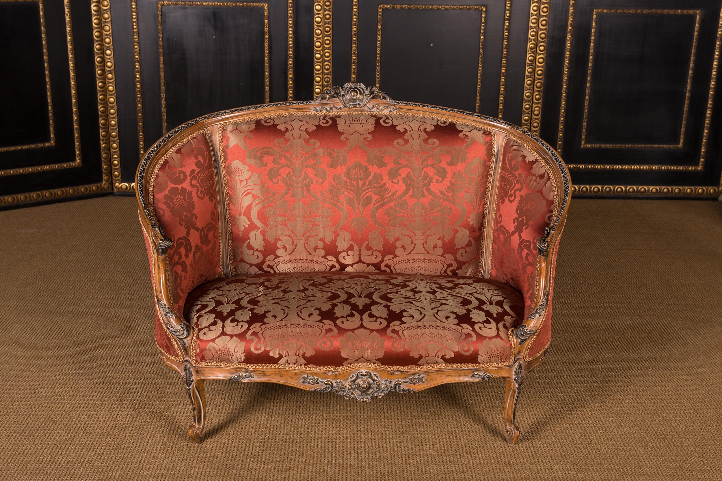 Solid beechwood, carved and painted. Semi circular rising backrest frame with openwork rocaille crowning. Appropriately curved frame with rich relief carved foliage. Slightly curved frame on curly legs. Seat and backrest are finished with a