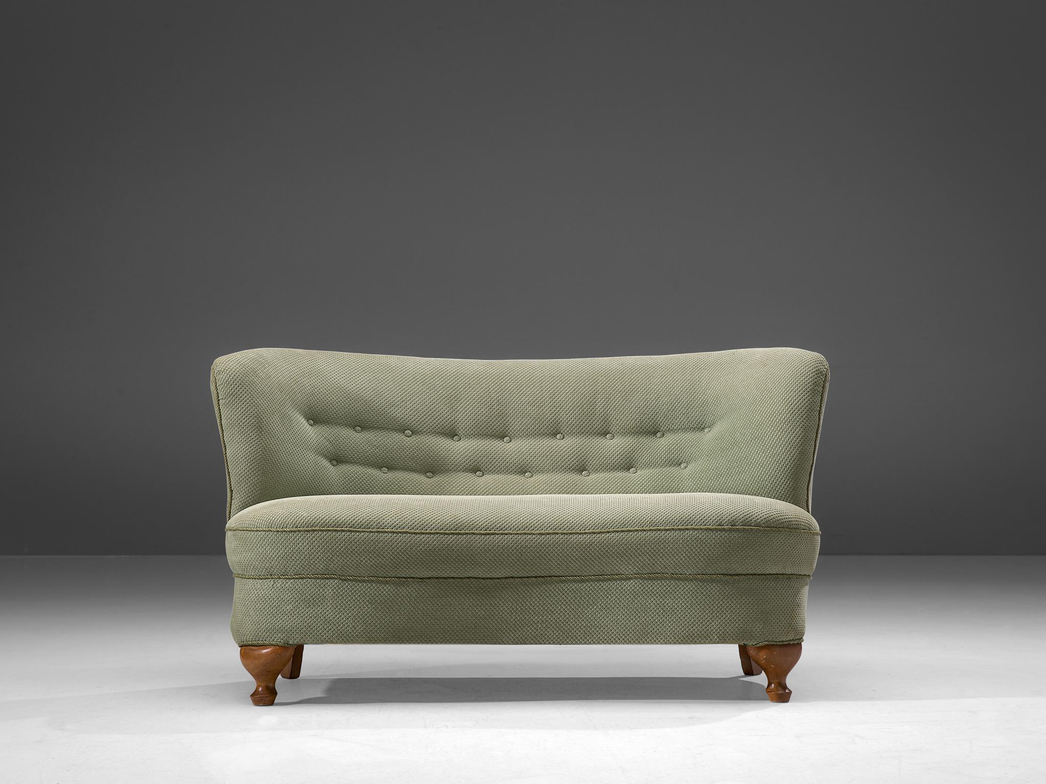 Settee, fabric and wood, France, 1950s

This elegant sofa is bold and round. The backrest flows slightly outwards when seen from the seat which is the reason that this chair has a very dynamic look. This voluptuous settee bears resemblances to the