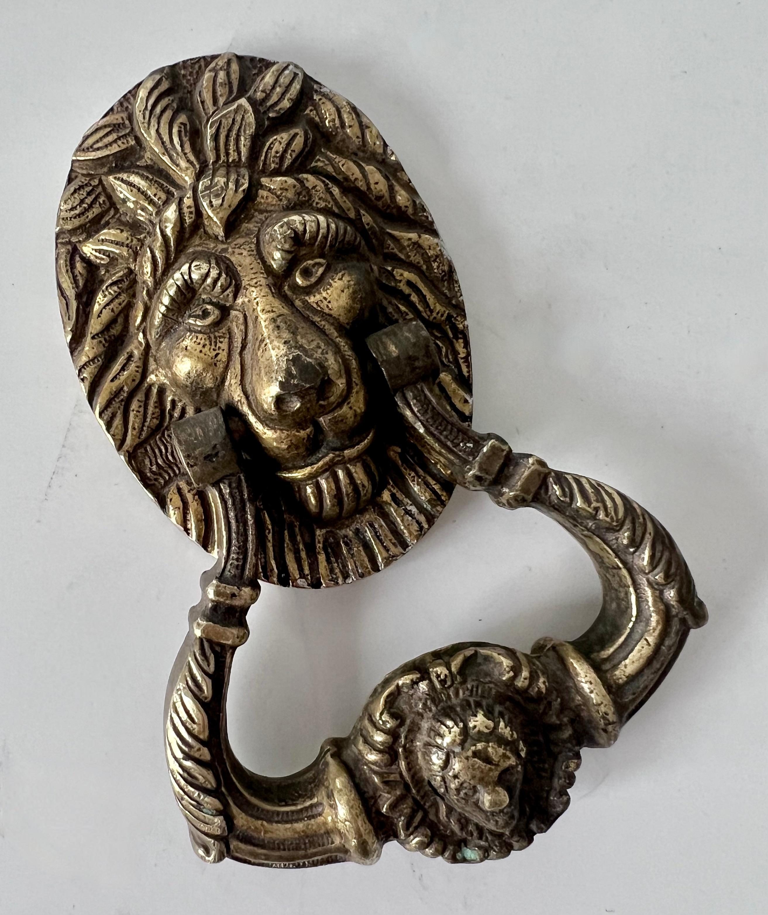 A wonderfully exaggerated lion in solid Brass - a door knocker acquired in Paris France.  A perfect setting for a door, entry in the front or rear or even an interior.