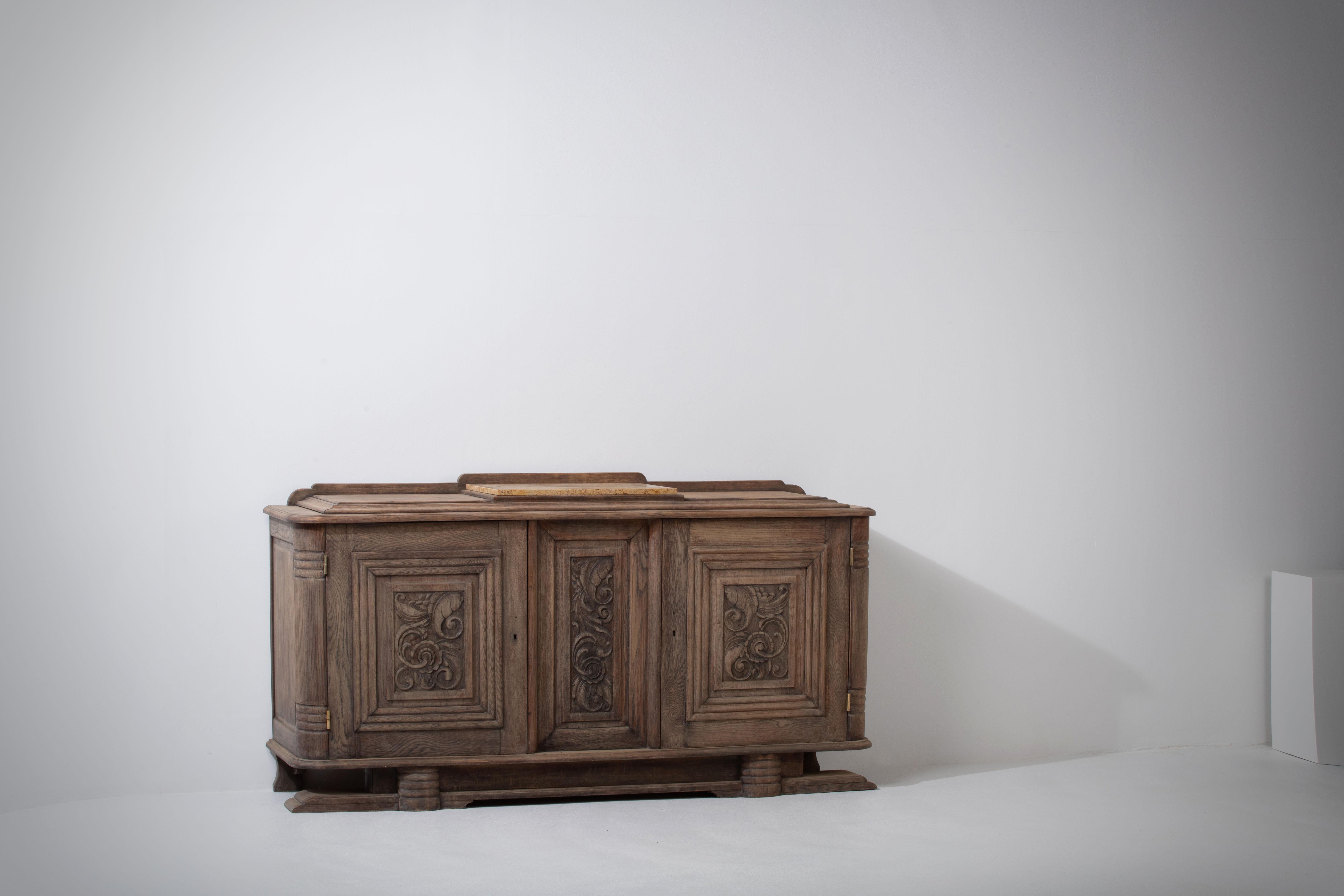 Introducing an exquisite patinated Art Deco sideboard from the 1940s, showcasing the timeless beauty of natural oak. This impressive piece exudes a rustic charm, embodying the distinctive French style of the era. Crafted with meticulous attention to