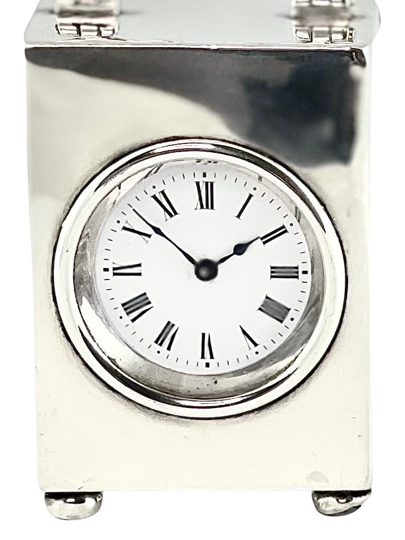 Miniature French timepiece carriage clock in English silver case, hallmarked London. The clock is delightful and would look wonderful adorning a desk. The movement was made in France and the case is from England. It was quite typical during this