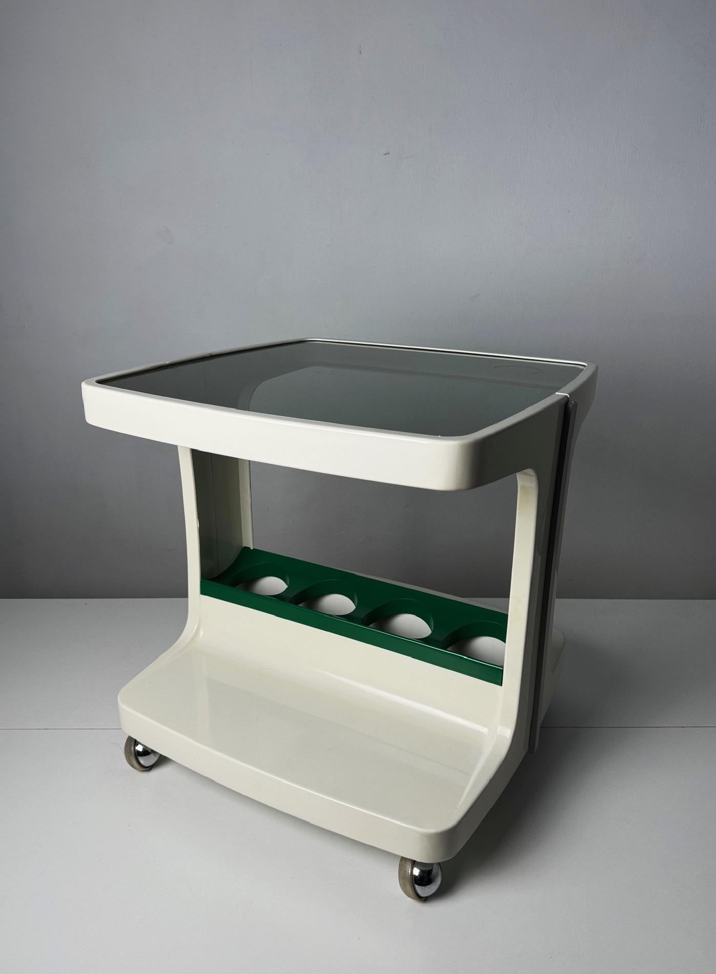 This French Space Age Bar Cart with Bottle Holder, designed by Marc Held for Prisunic in the 1970s, embodies the innovative spirit of an era captivated by futuristic forms and functionality. Known for his modernist approach, Marc Held was a