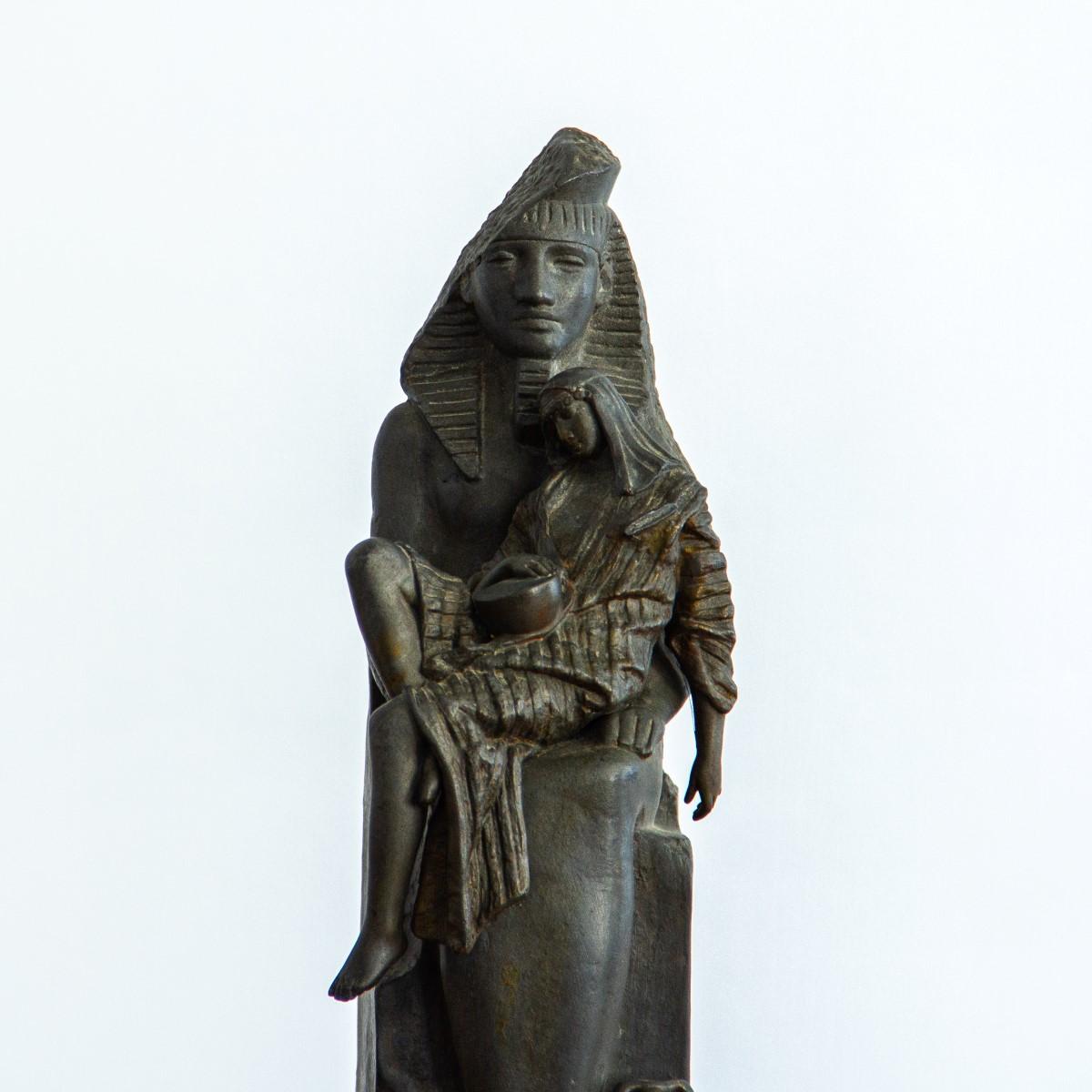 A French spelter made table sculpture of an Egyptian man sat upon an enthroned Khafre of Gizeh, Egypt, circa 1880.