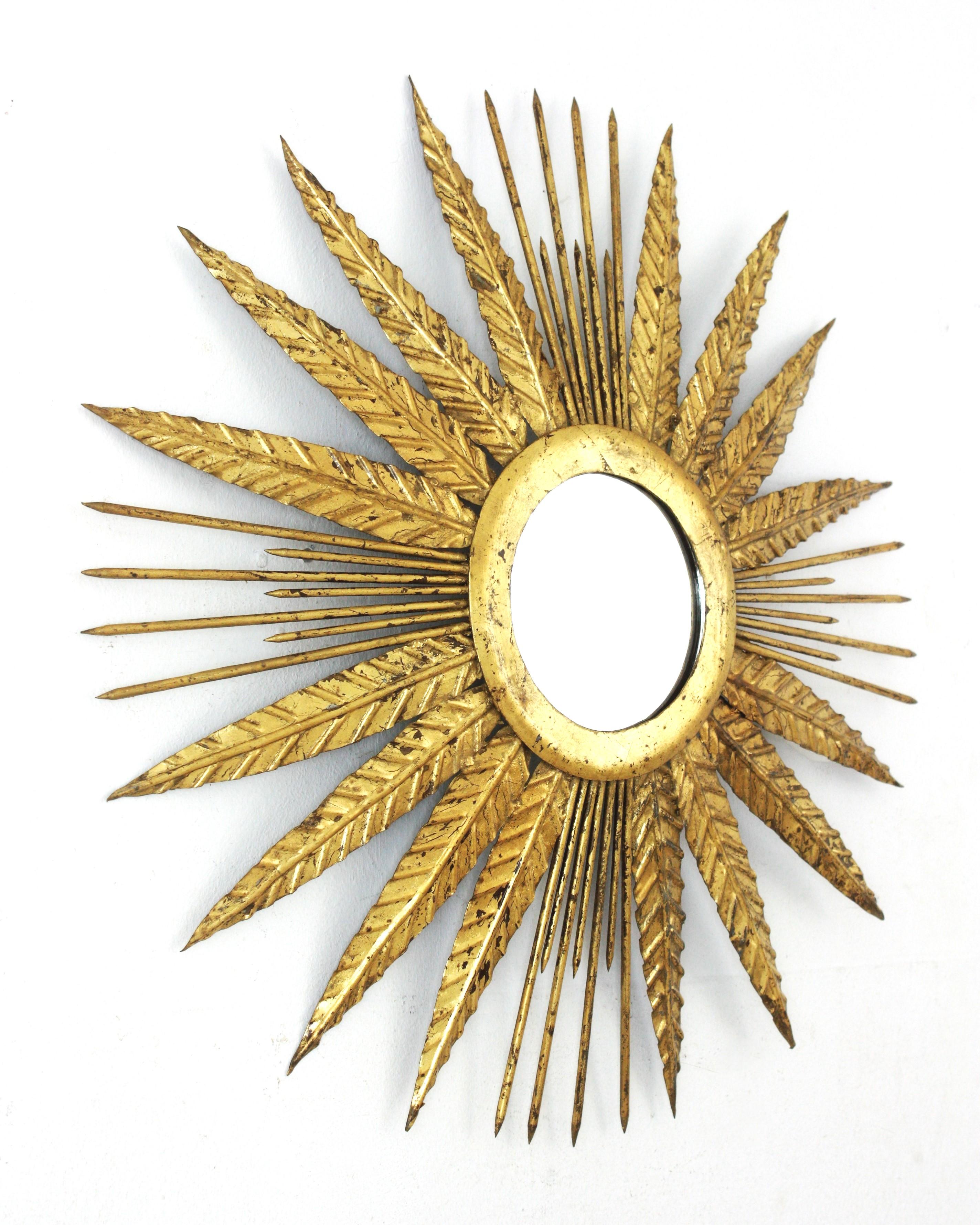 Mid-Century Modern French Sunburst Mirror in Gilt Iron with Spikey Leafed Frame, 1940s For Sale
