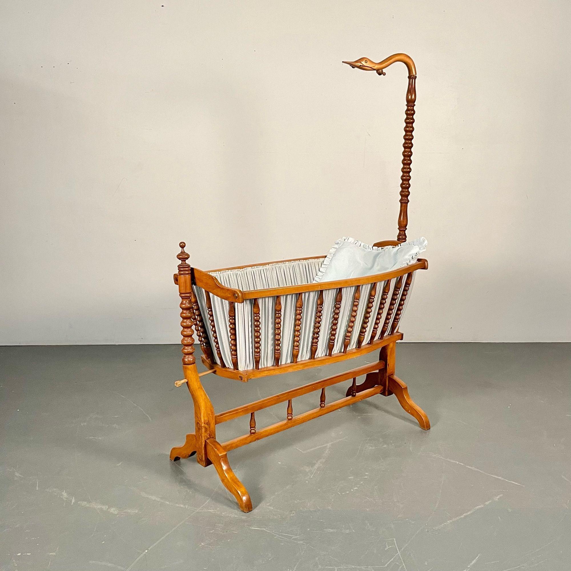 French Spindled 19th Century Walnut Decorative Cradle, Swan Motif

A stunning cradle or baby crib. The birch or walnut wood bassinet is simply darling. The long swan neck in place to hold a mobile for the baby to play with leading to a swinging crib