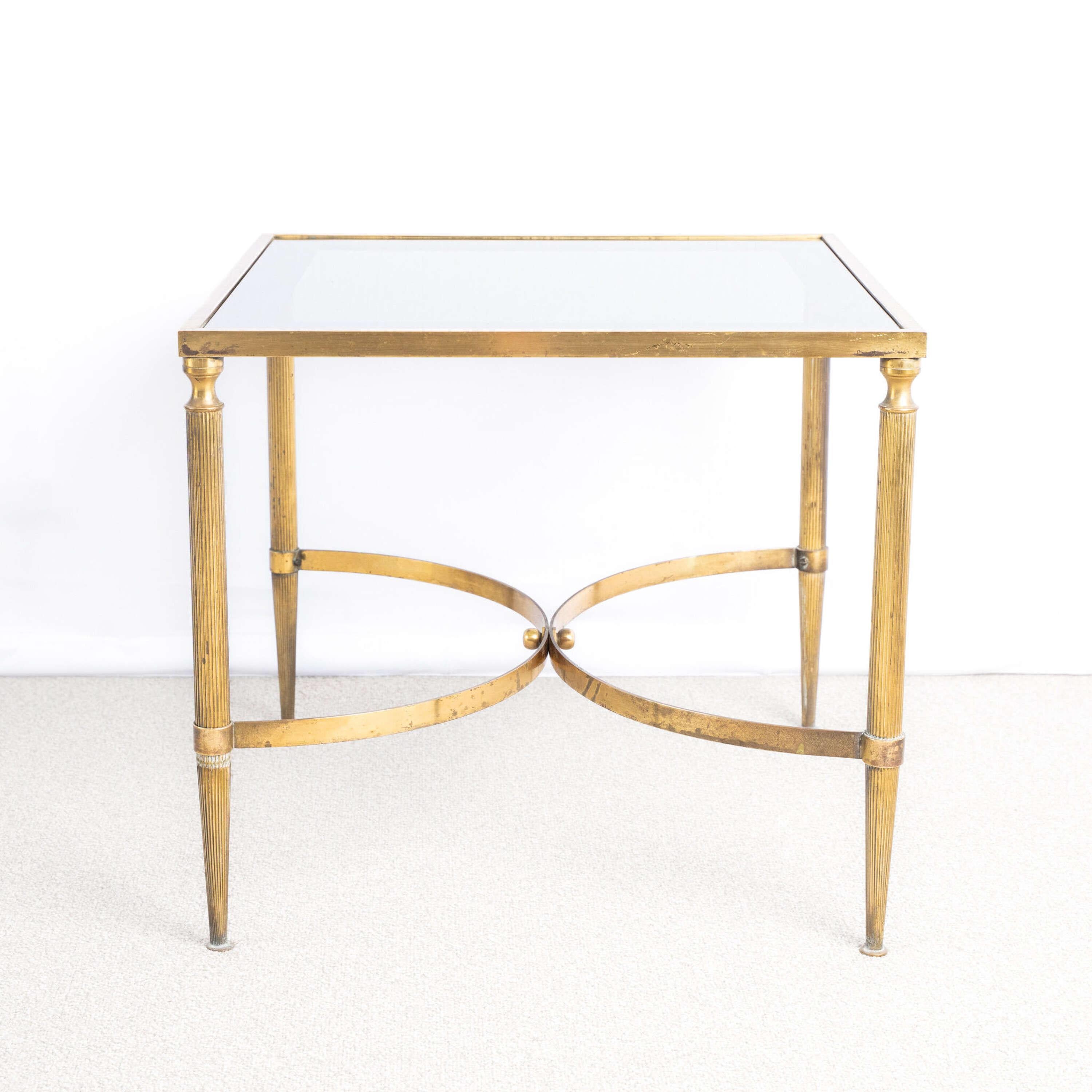 Square Brass and Glass Side Table.
With unusual mirrored border to top.
Sitting on reeded legs with curved stretcher.

France, circa 1970.

Height - 45.5cm
Width - 50cm
Depth - 50cm
Please message if any further info or photos are
