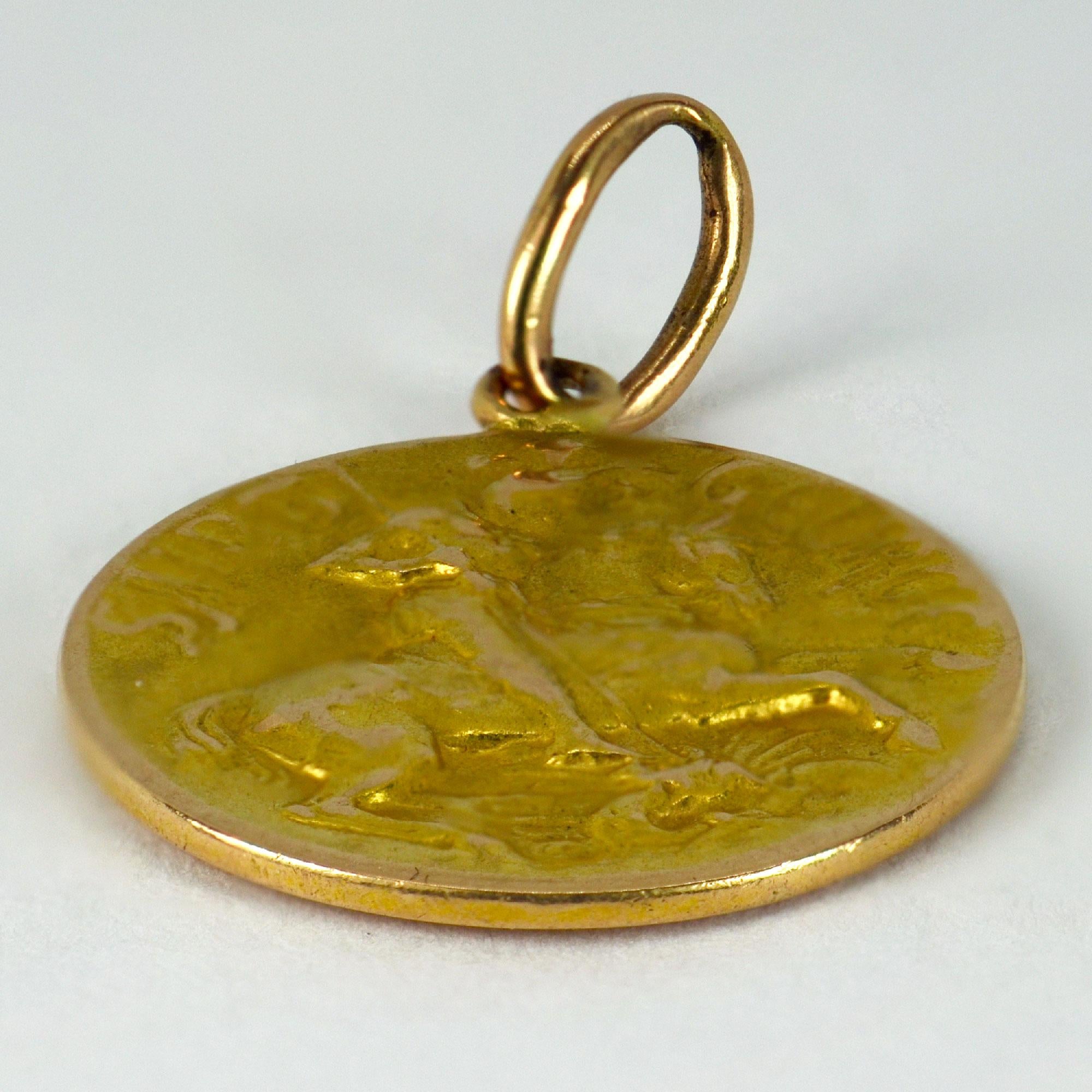 A French 18 karat (18K) yellow and rose gold charm pendant designed as a medal depicting St George defeating the dragon. The reverse depicting a ship with the motto ‘Tempestate Securitas’. Stamped with the owl for 18 karat gold and French import.