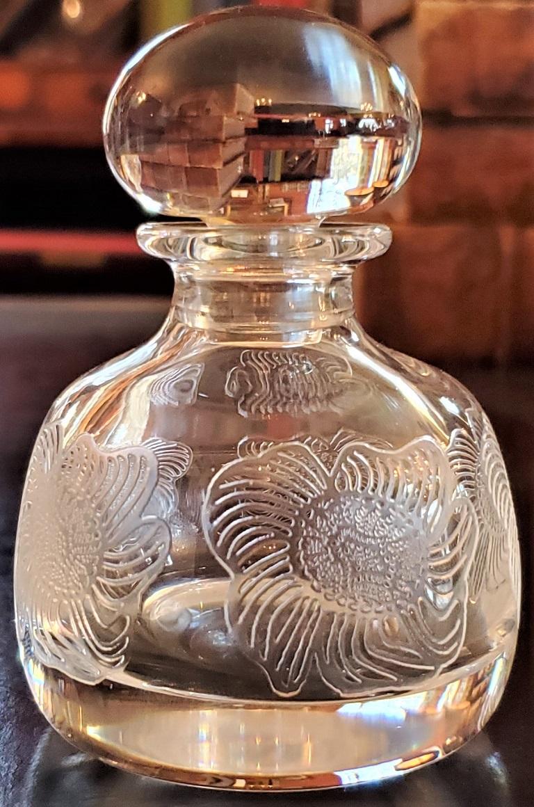 Presenting a glorious French St Louis perfume bottle.

High quality and made in France!

It consists of a beautiful St Louis crystal perfume bottle with etched flowers on the sides and a gorgeous bulbous stopper that acts like a prism.

Made