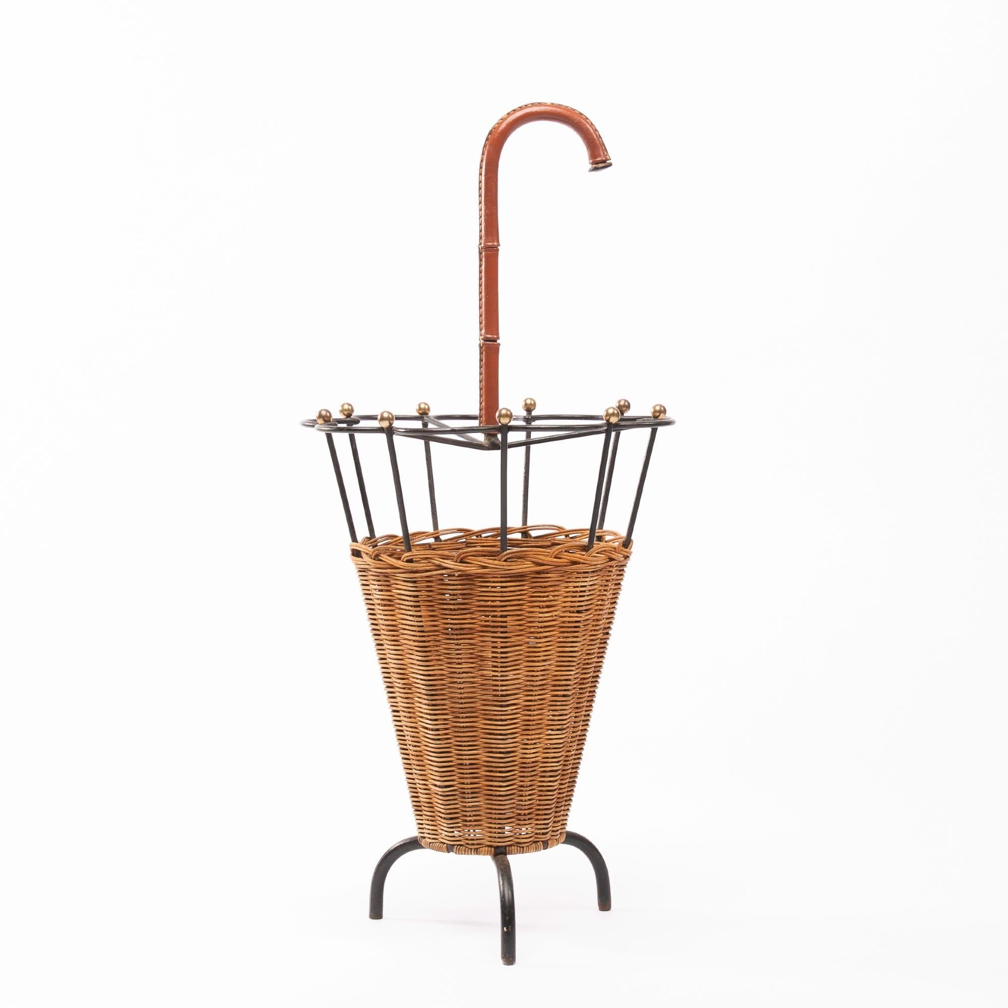 Nice, unusual umbrella stand attributed to Jacques Adnet (France).

We did not find a publication about this item from an address where we bought pieces from Jacques Adnet.

The object consists of a steel frame sheathed with rattan, the handle