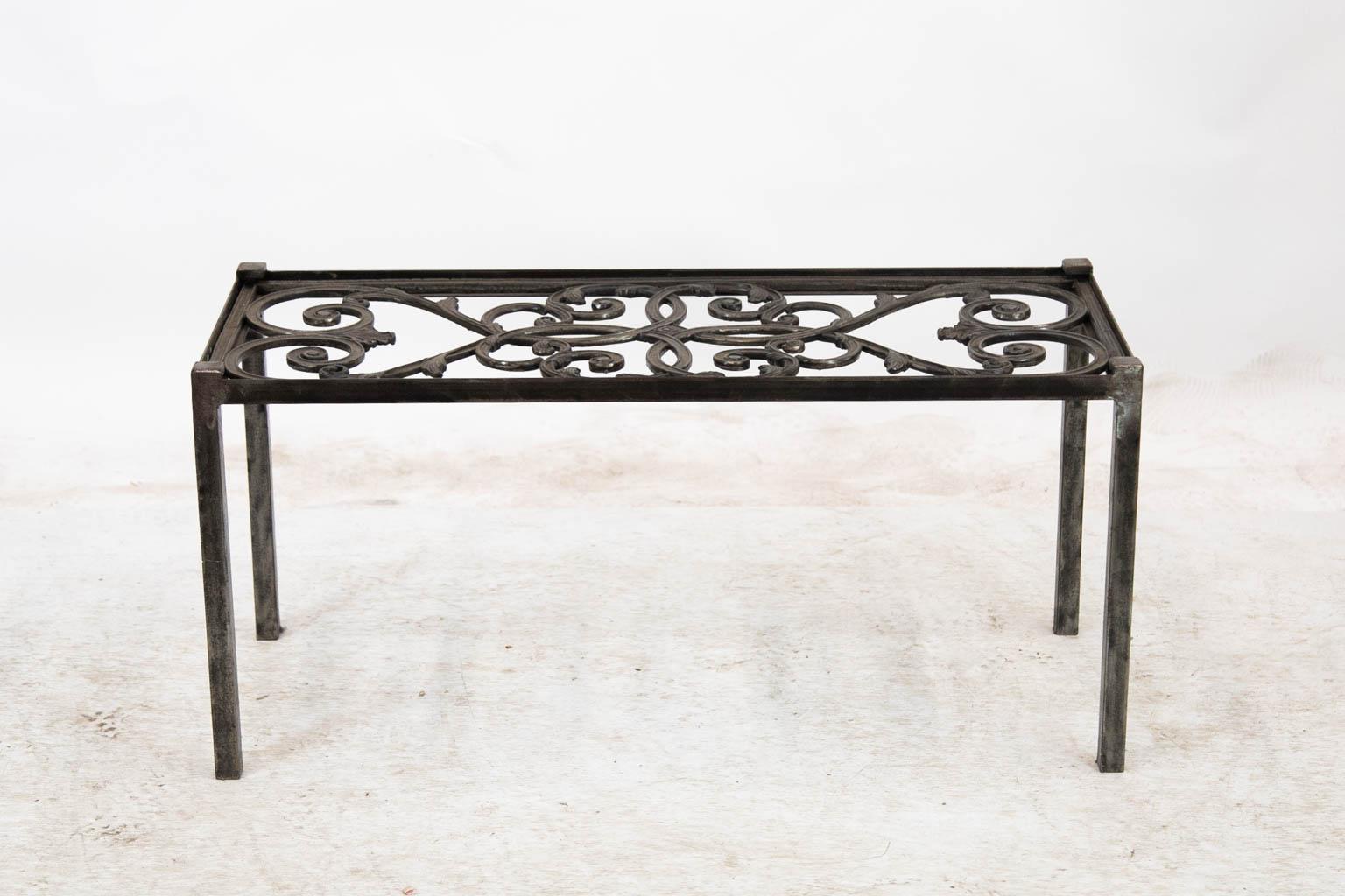 This coffee table was made from a 19th century molded steel decorative panel to which the legs and frame have more recently been custom made to fit. It is offered without a top so the purchaser can decide a preference of glass or acrylic.