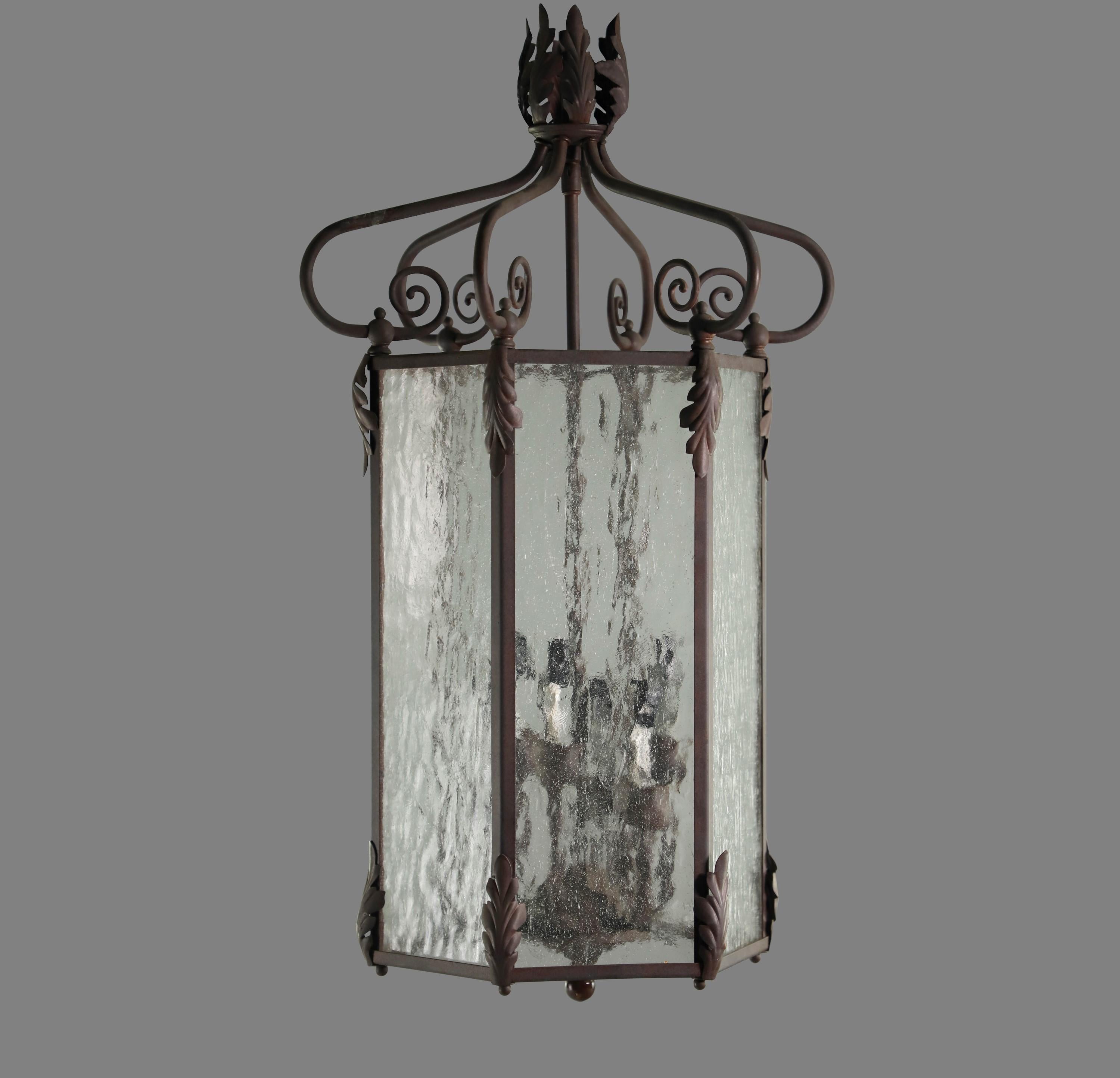 20th century pendant lantern with bronze finish with six clear textured glass side panels. Cleaned and restored including chain and canopy. Takes 6 candelabra style light bulbs. Your choice of with white or cream colored candle sleeves. Please note,