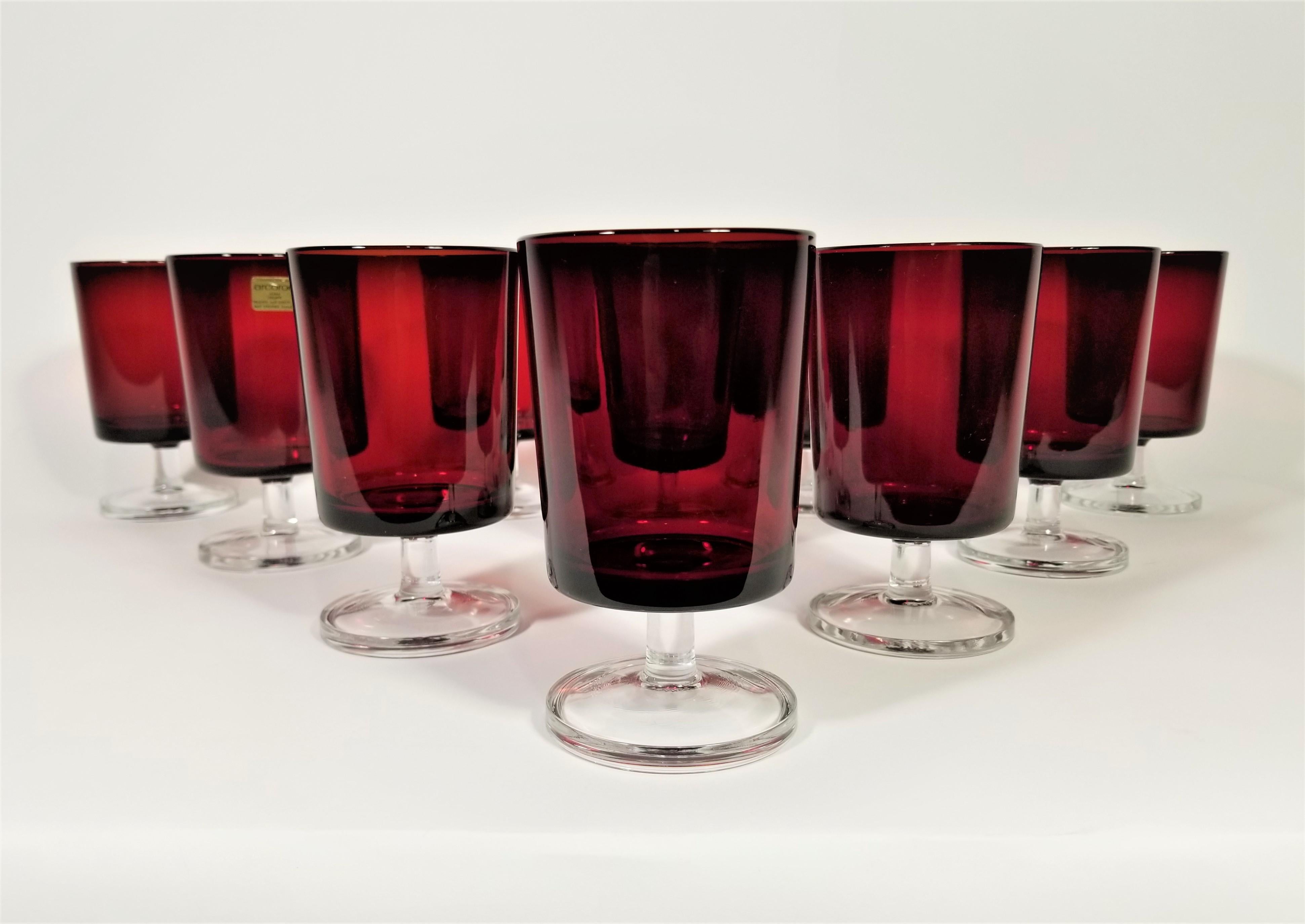Set of 10 midcentury 1960s French Arcoroc stemware glassware barware. Ruby red with clear stem, all glasses marked France on bottom. Some still retain original marking stickers. Elegant addition to any table or bar.