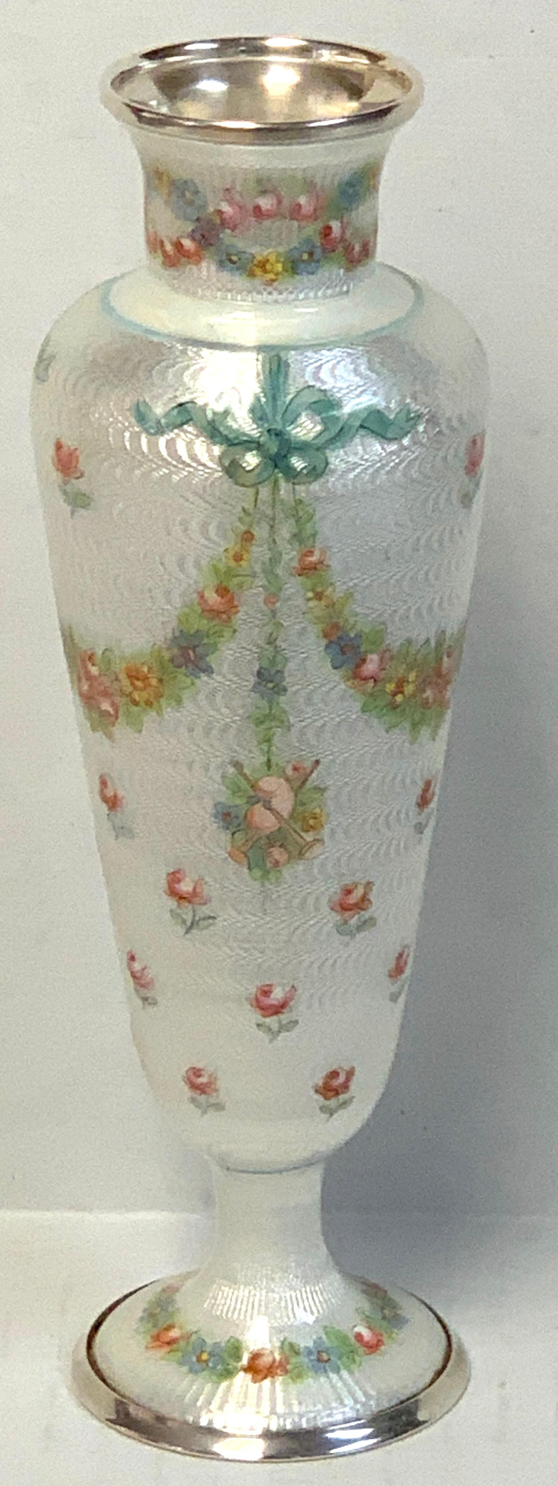 French sterling and guilloche enamel neoclassical vase, magnificent multicolored enamel work of typical French ribbons, florals and vignettes. Unmarked. The vase stands 8 inches high, the opening is 1.5