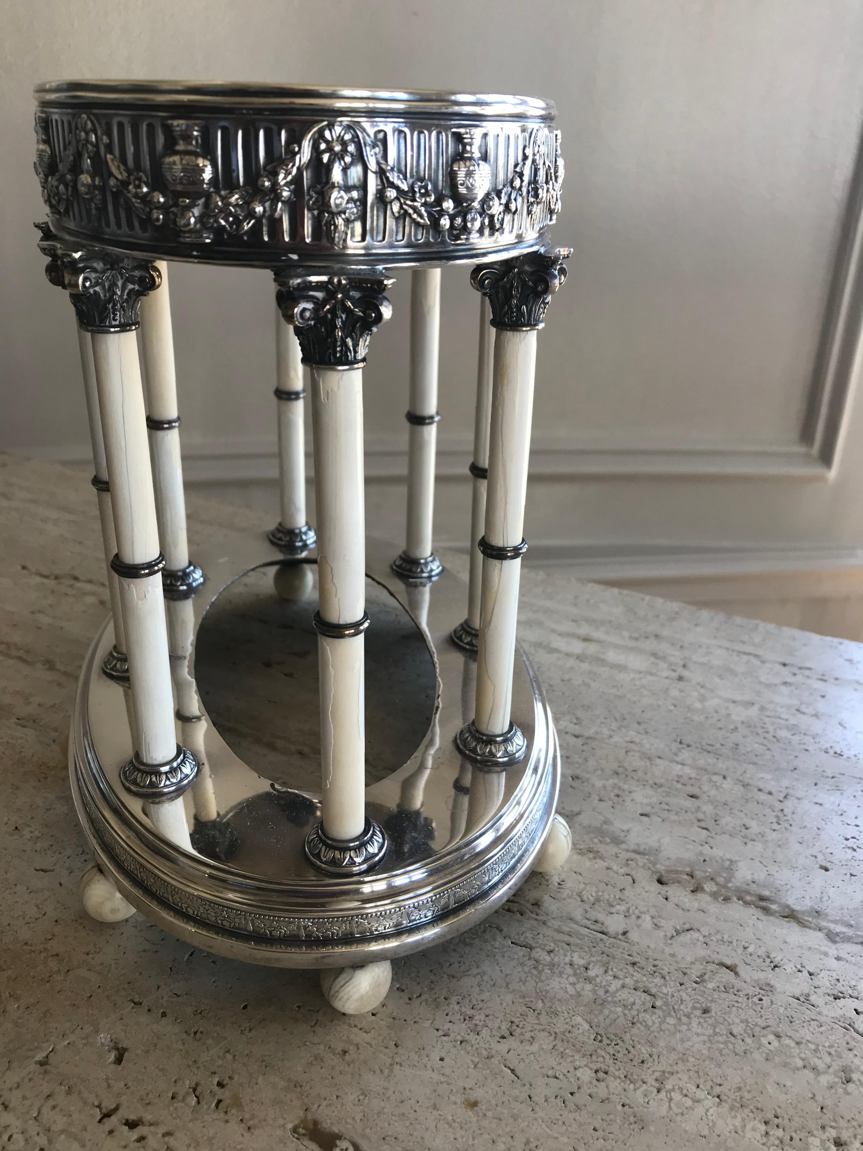 Beautiful and finely detailed French sterling silver centerpiece, featuring classic swags and urns supported by bone corinthian columns and raised on ball feet, circa 1900.