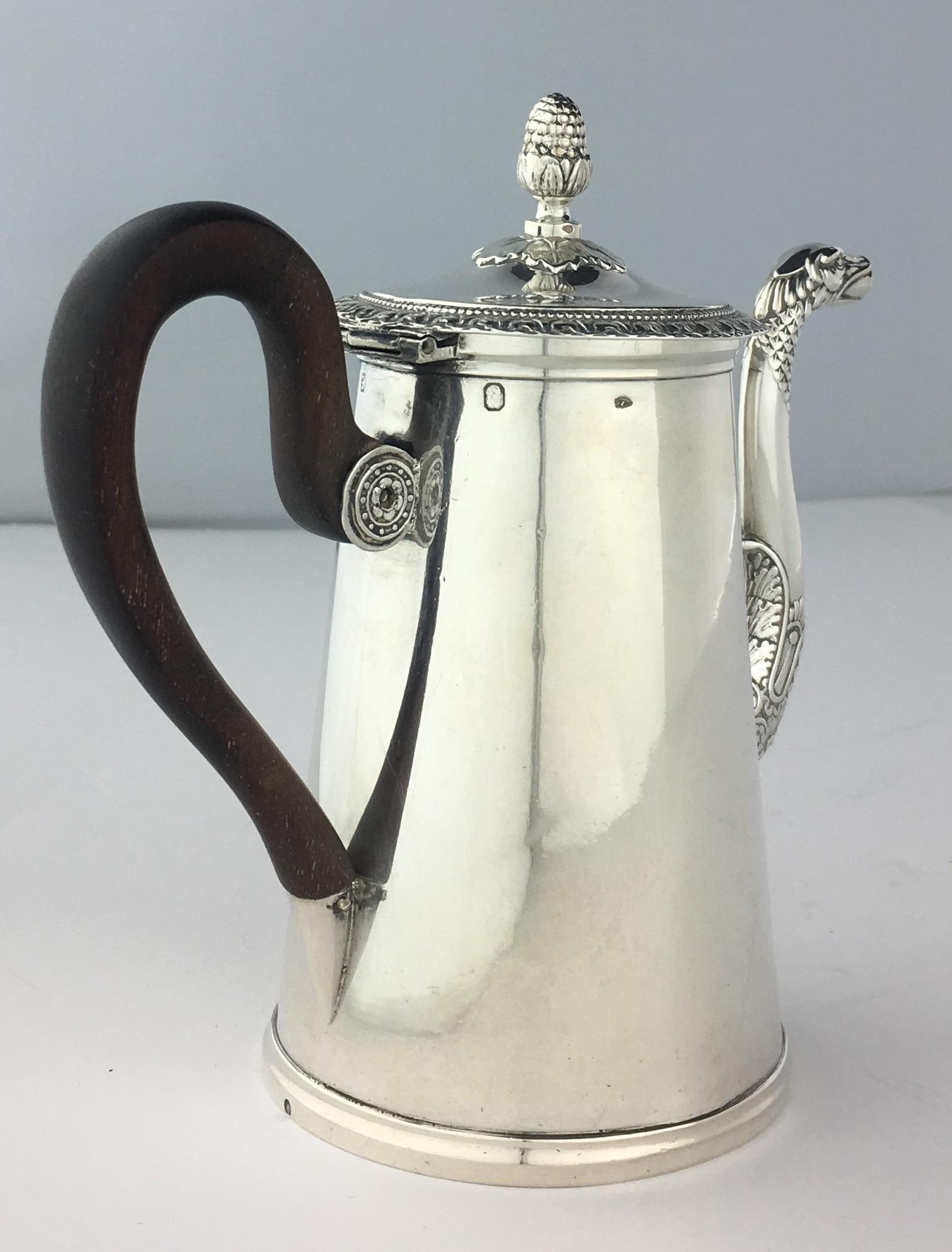 An elegant 19th century French hallmarked sterling silver chocolate pot with embossed decoration. The pot is decorated with a band around the top. There is embossed decoration on top and bottom of mouth and around silver handle attachment. 

Pot has