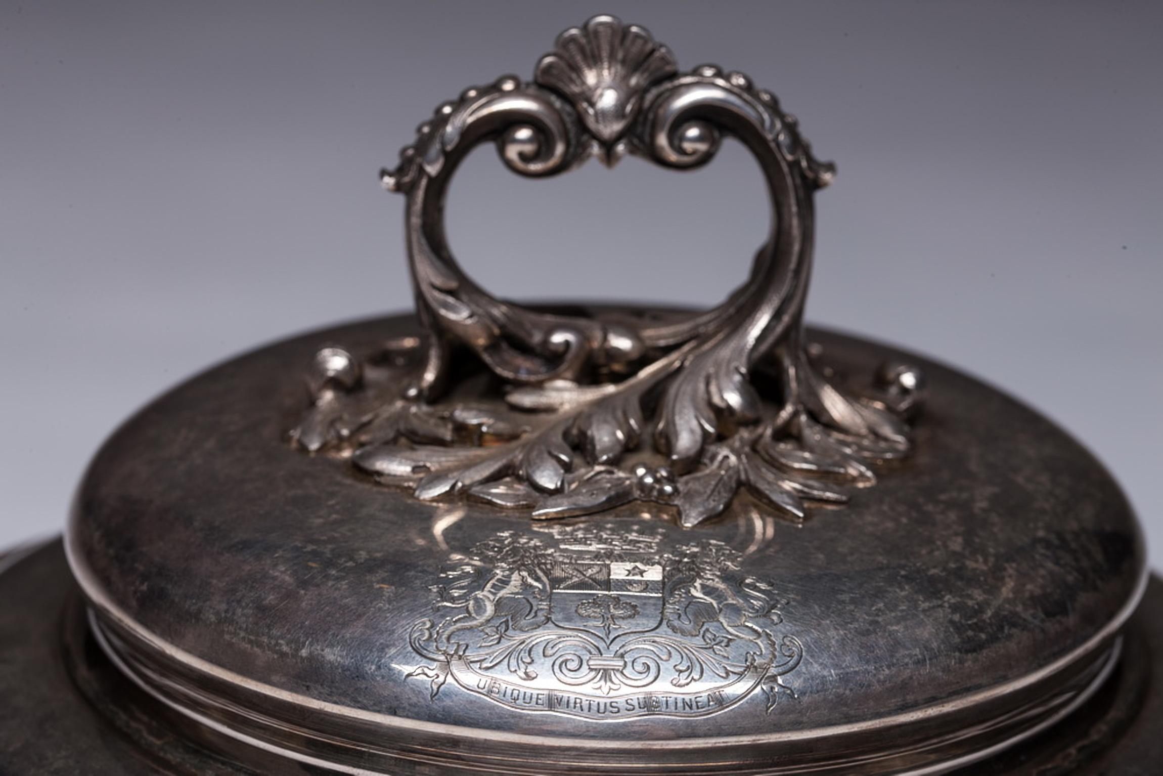 Antique French sterling silver Louis XV style soup or vegetable tureen, raised on four scroll feet and panelled body and lid accented with chased rocaille borders. The domed lid is surmounted by a remarkable large cast and chased finial depicting a