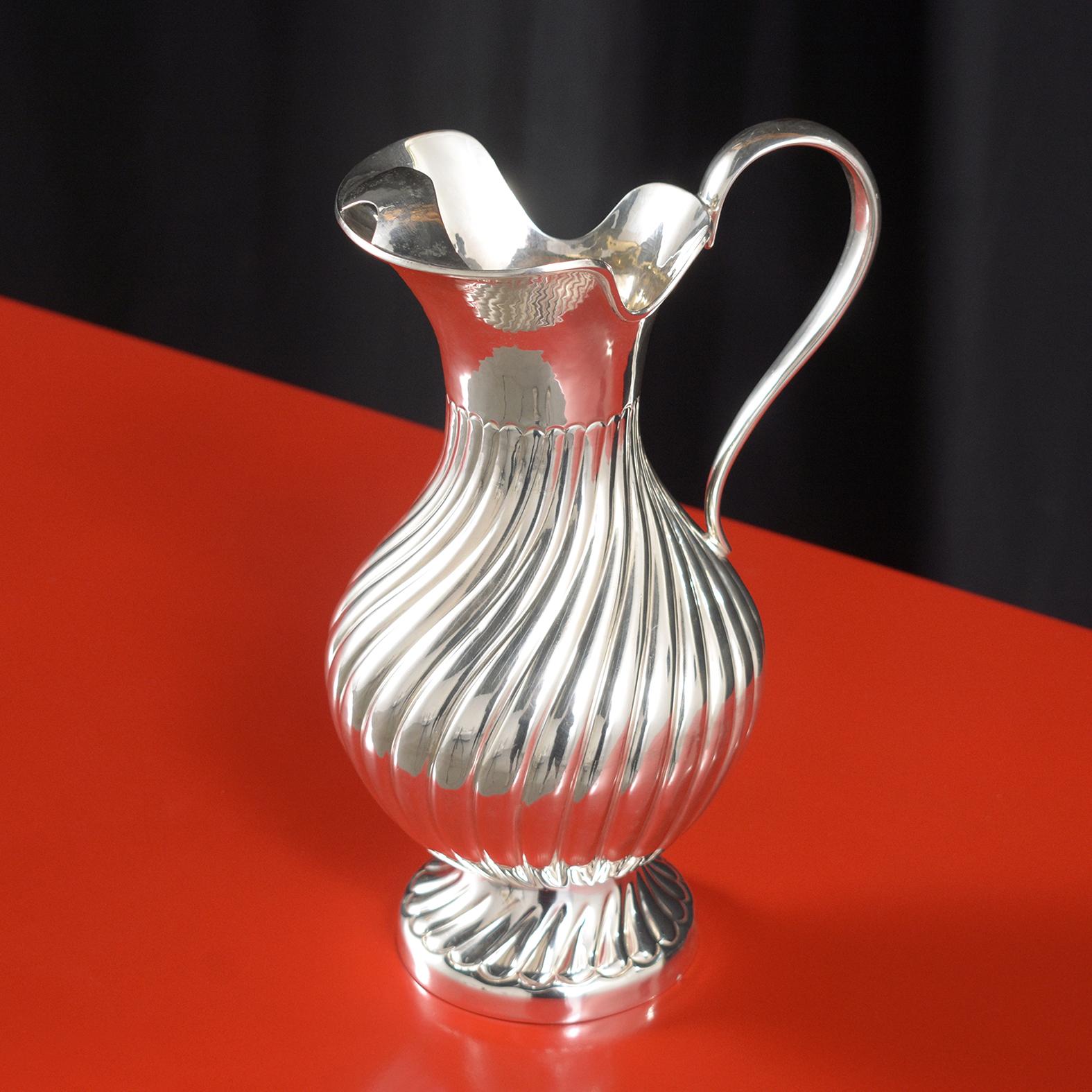 Presenting our exquisite Sterling Silver Water Pitcher, a testament to classic craftsmanship and timeless design, now expertly restored to its original splendor. Crafted from high-quality 925 stamped sterling silver, this stunning piece showcases