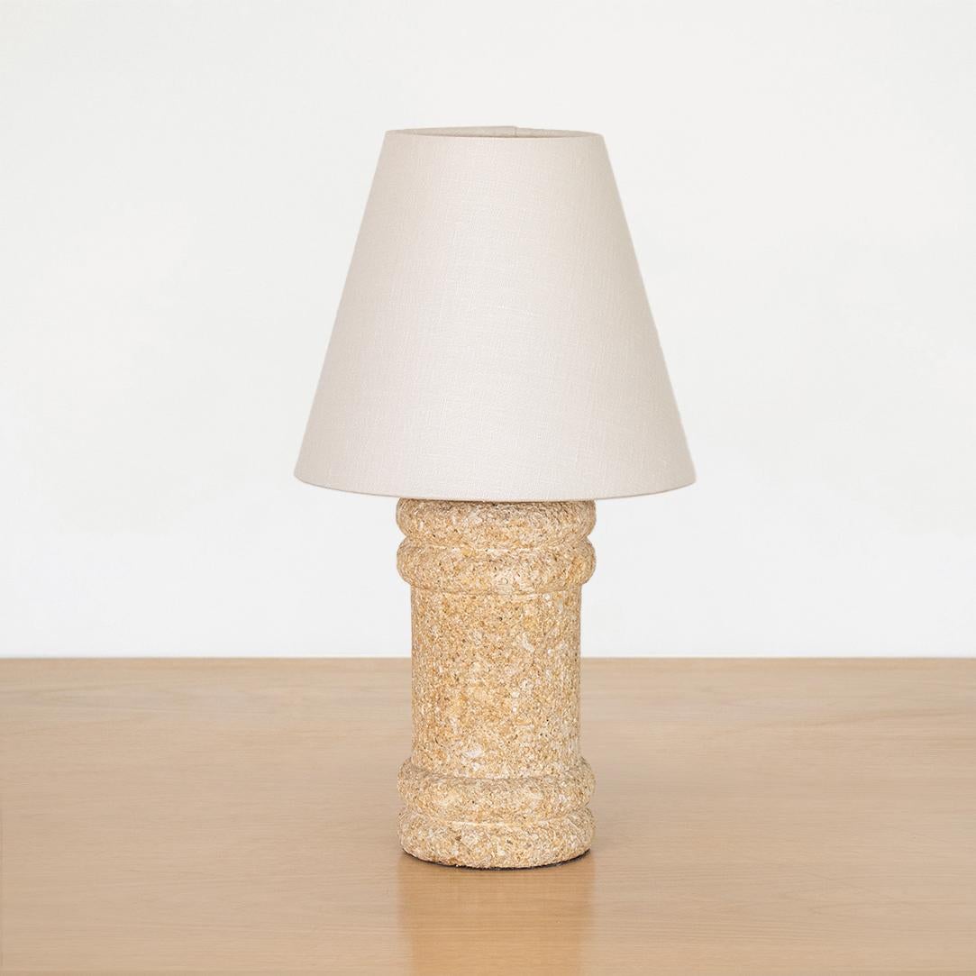 Vintage French stone table lamp with natural brown stone column base with ribbed detail. New off-white tapered linen shade and newly re-wired.

Measures: base diameter - 4.25