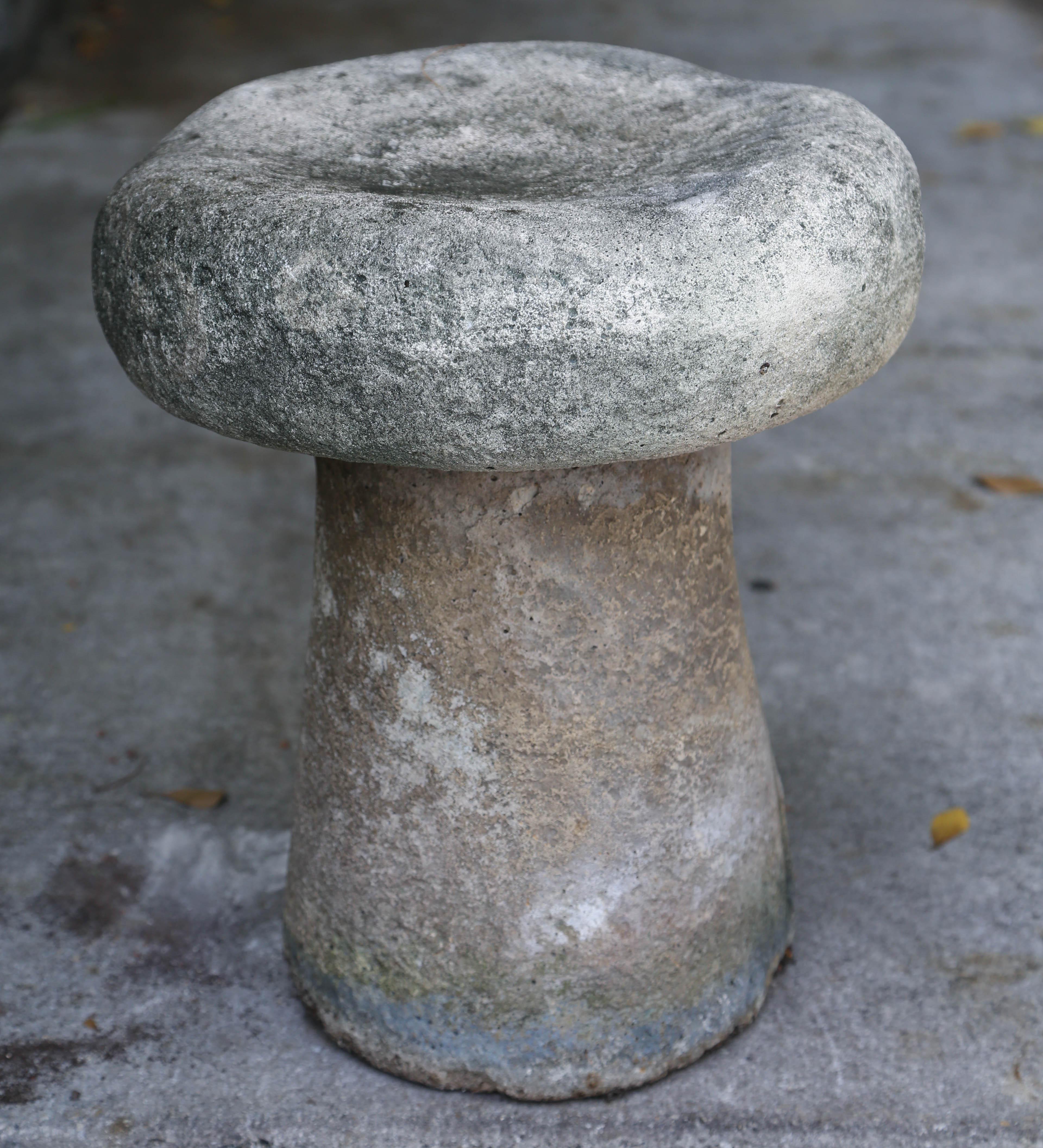 Vintage one piece stone garden seat in the shape of a mushroom.