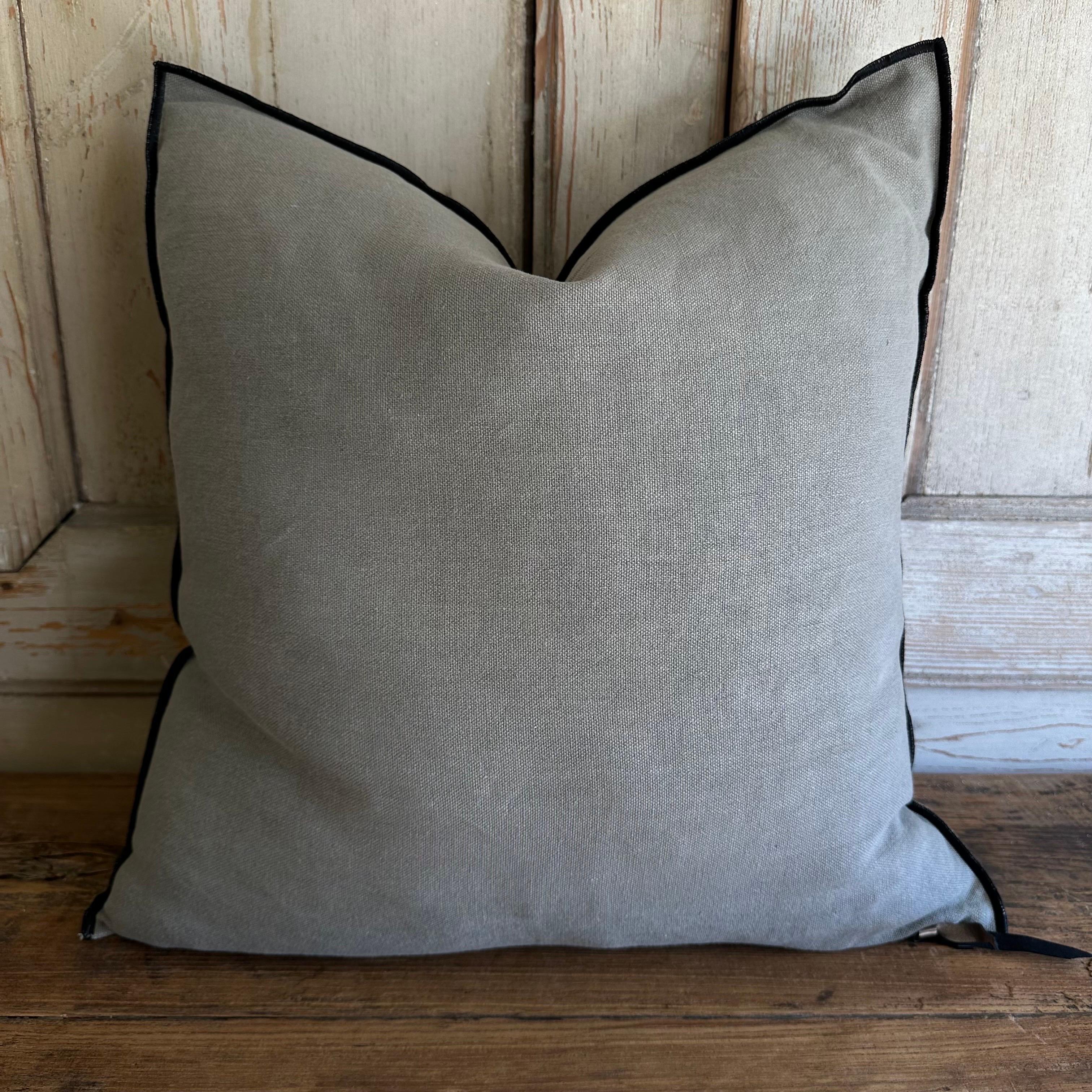 French stone washed linen accent pillow. 
Color : CAMO a deep muddy green with warm brown tones, this color reads a dark green gray, with a nubby textured style pillow with a stitched edge, metal zipper closure. 
Size: 22