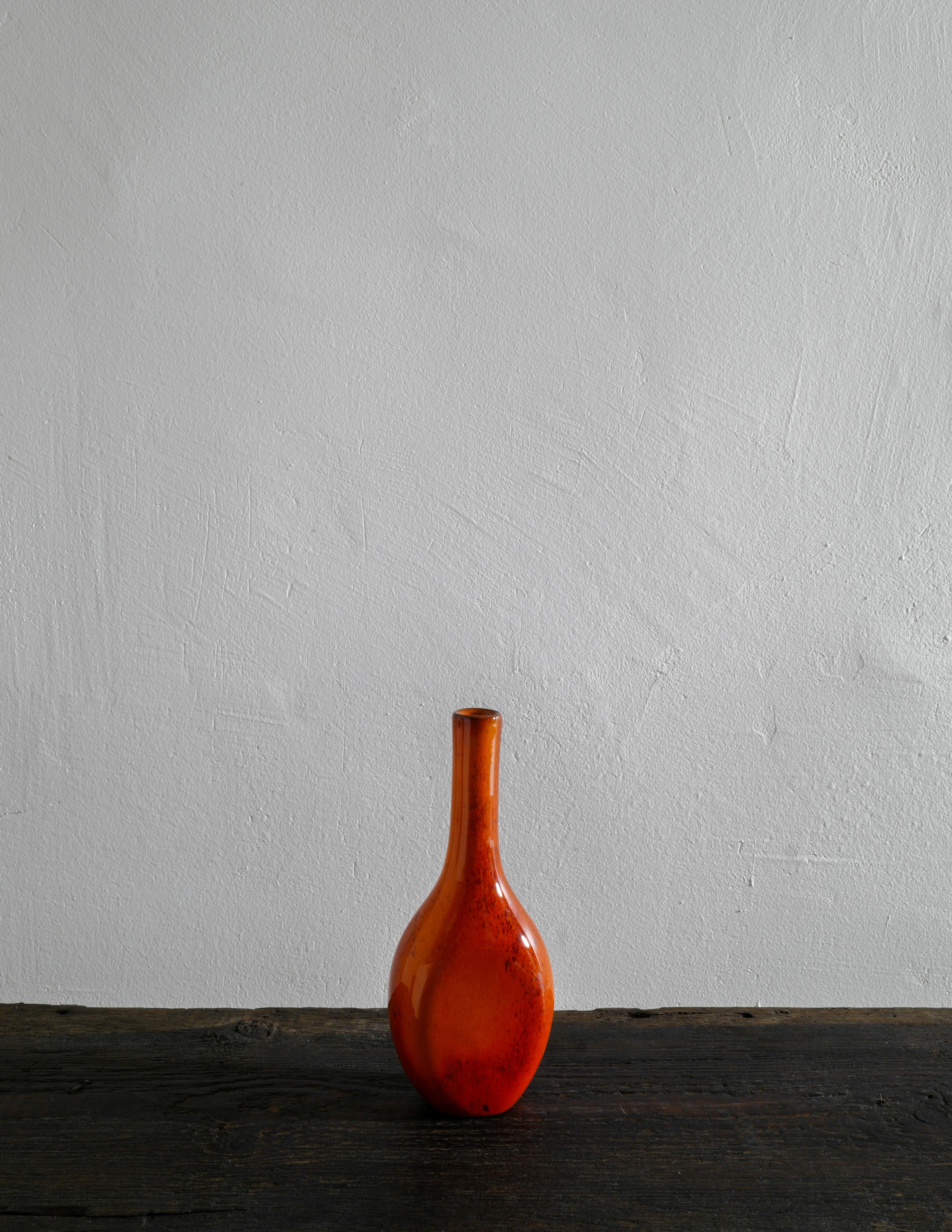 Rare french vase in a warm red color and in style of George Jouve produced in the 1950s. In good vintage condition with small signs from age and use. 

Dimensions: 
H: 21 cm
W: 8,5 cm
D: 5 cm.
    