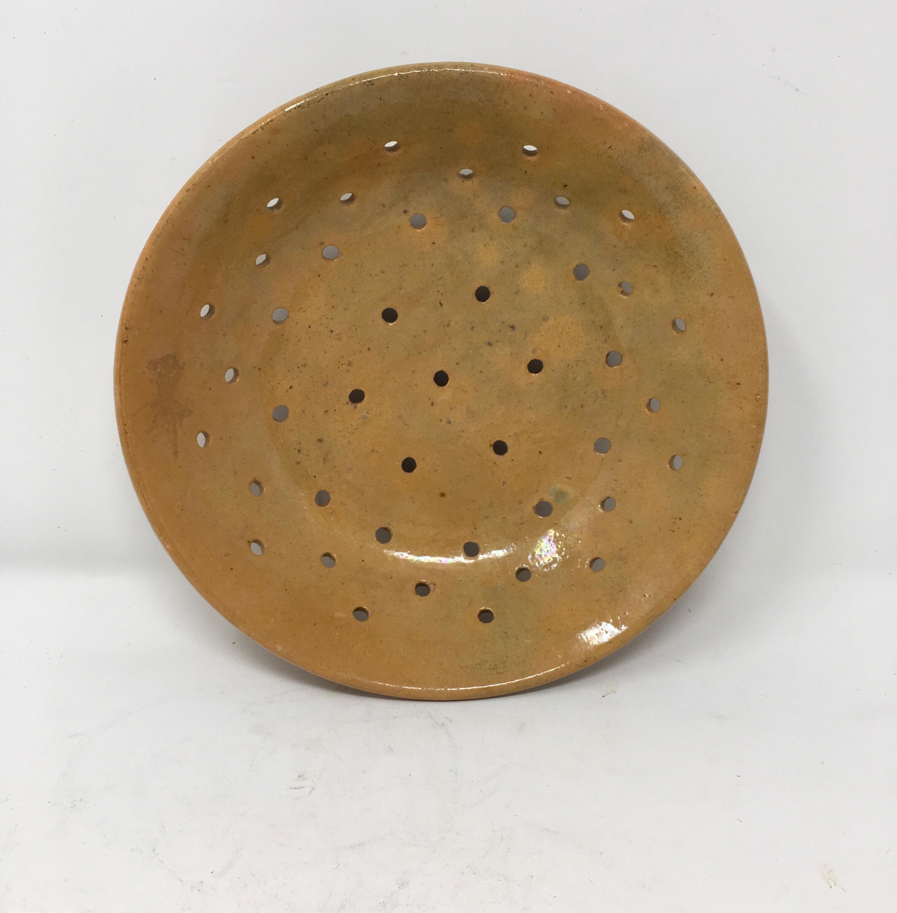 Found in the South of France, this handmade antique French 'Faisselle' cheese mold is constructed in a glazed pottery. Faisselle or 'framage frais' (fresh goat cheese) was made by curdling unpasteurized milk and then straining it. This mold has been
