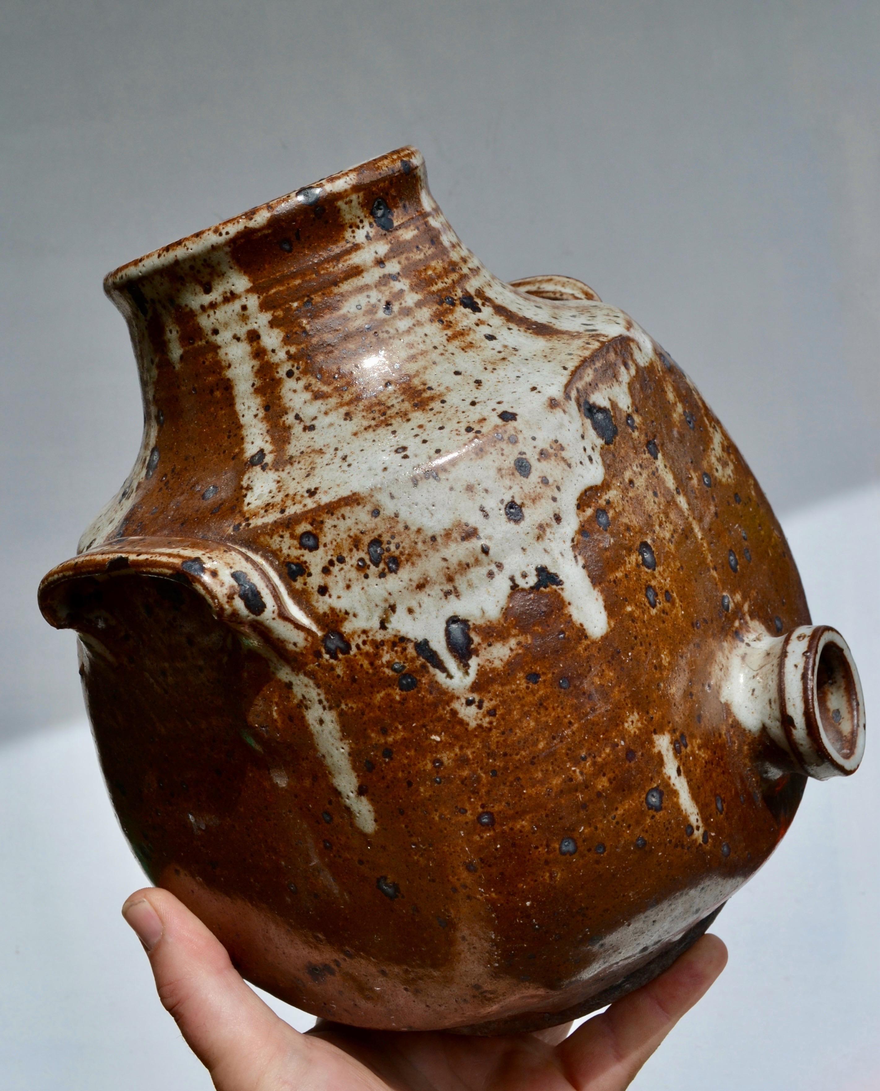 Vintage French vinegar jar in glazed pyrite stoneware, likely produced in La Borne during the 1950s.

Featuring a warm brown glaze with natural variations and ash drips, this utilitarian piece reflects the traditional craftsmanship of French rural