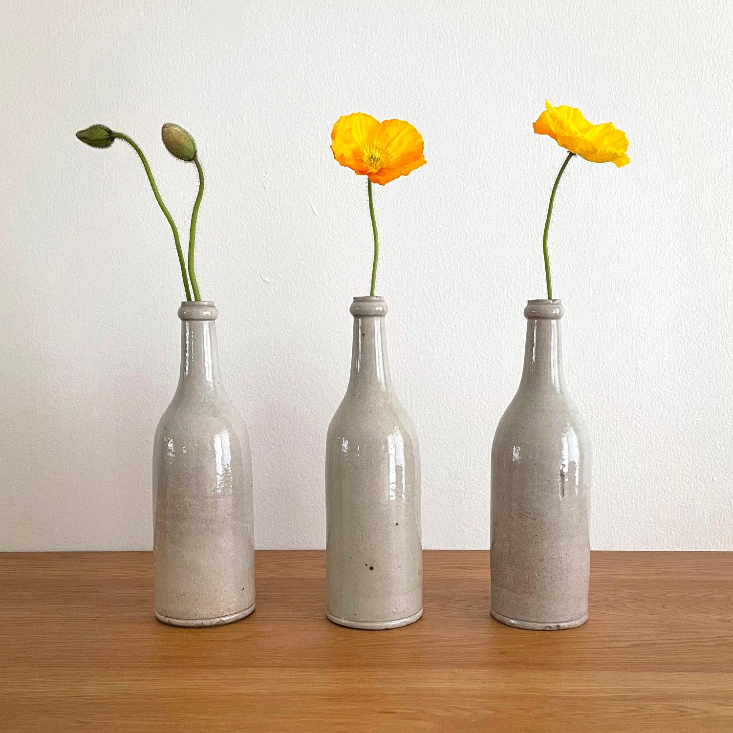 French stoneware wine bottles
Organic composition and feel 
Naturally occurring imperfections 
Various degrees patina which add to the character of each bottle'=
Perfectly imperfect
Additional photos upon request
Please note, these bottles have not