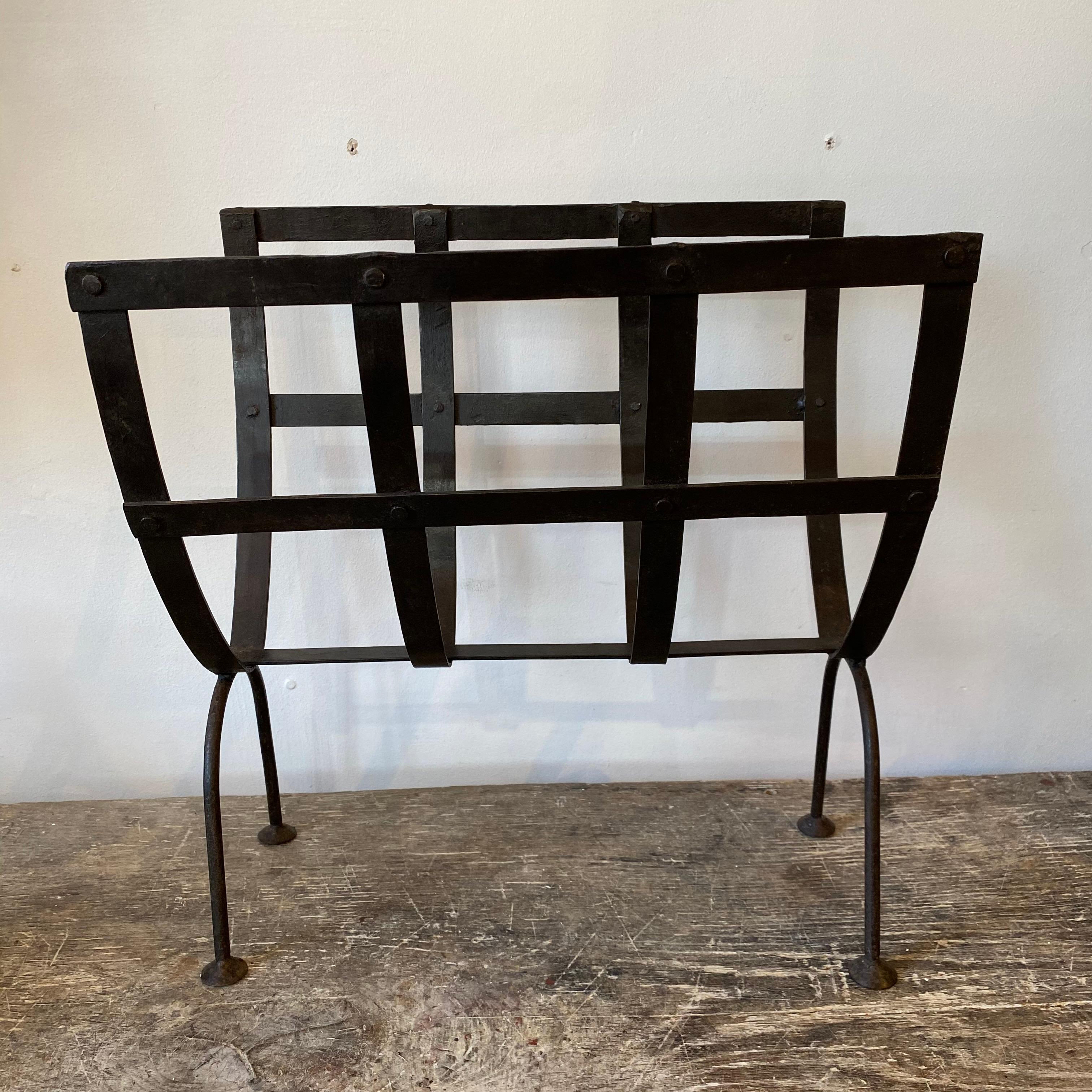 1950-1960's French iron strap work magazine rack. 
This piece has a strong look to it, at home in both a traditional or contemporary setting. Good space to store books, magazines, newspapers.

  