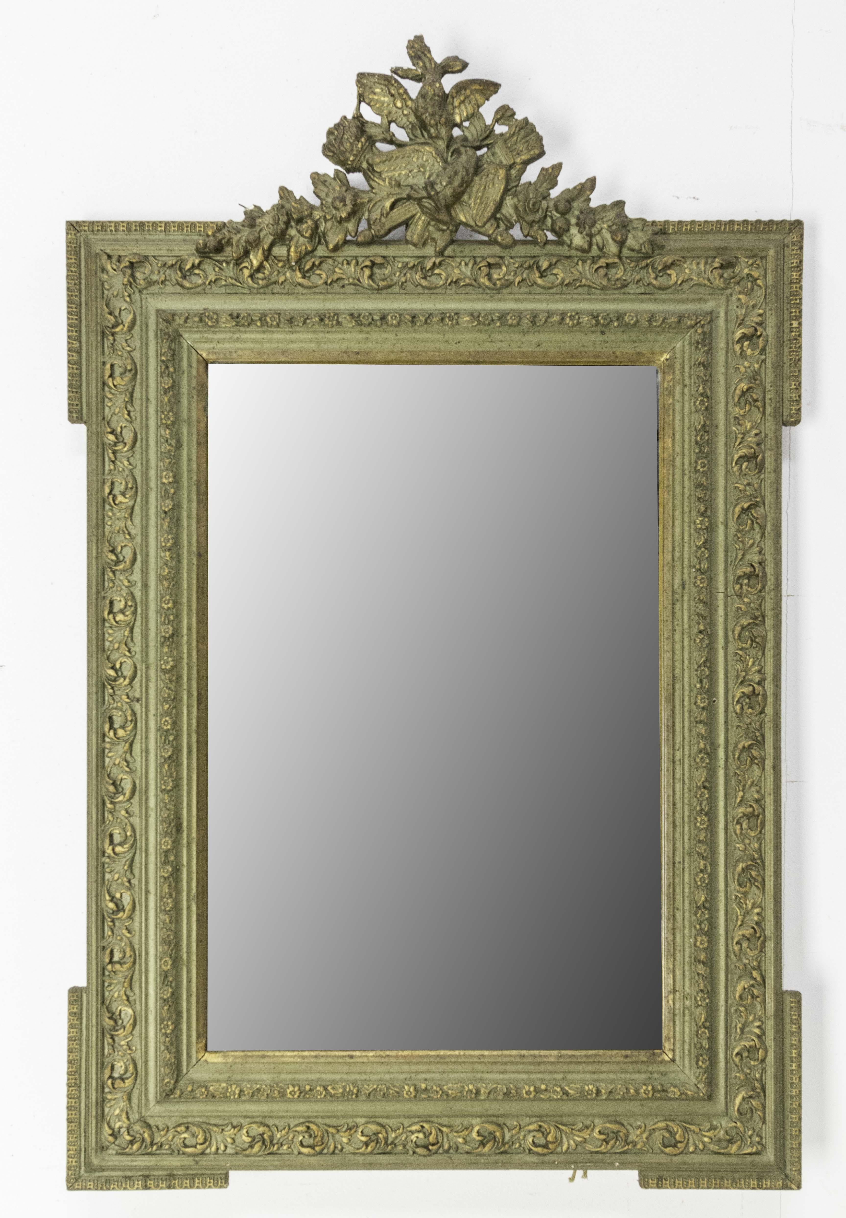 French bronze patina stucco mirror 
Beautiful frame with an ornamentation on the top with two birds on a vegetal decor 
Plant decoration on the stucco frame.
Original mirror
Made circa 1890.

Shipping:
L65 P7 H87,5 cm 7 Kg.