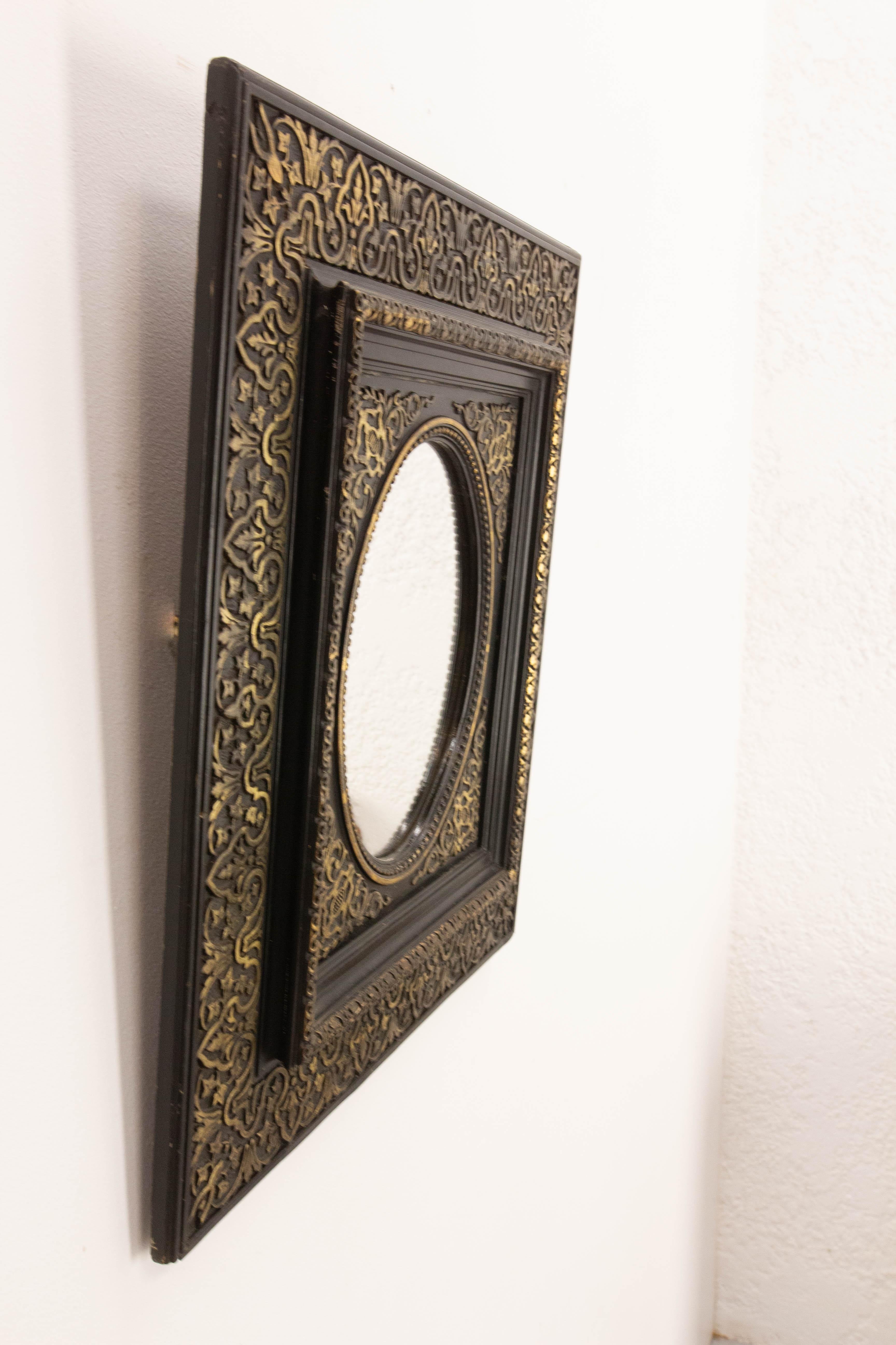Napoléon III wood and stucco wall mirror painted of black and gold.
During the Napoleon III period, artists had a keen interest in everything to do with Eastern art. This explains the motifs on this mirror, created to invite travel.
The black and