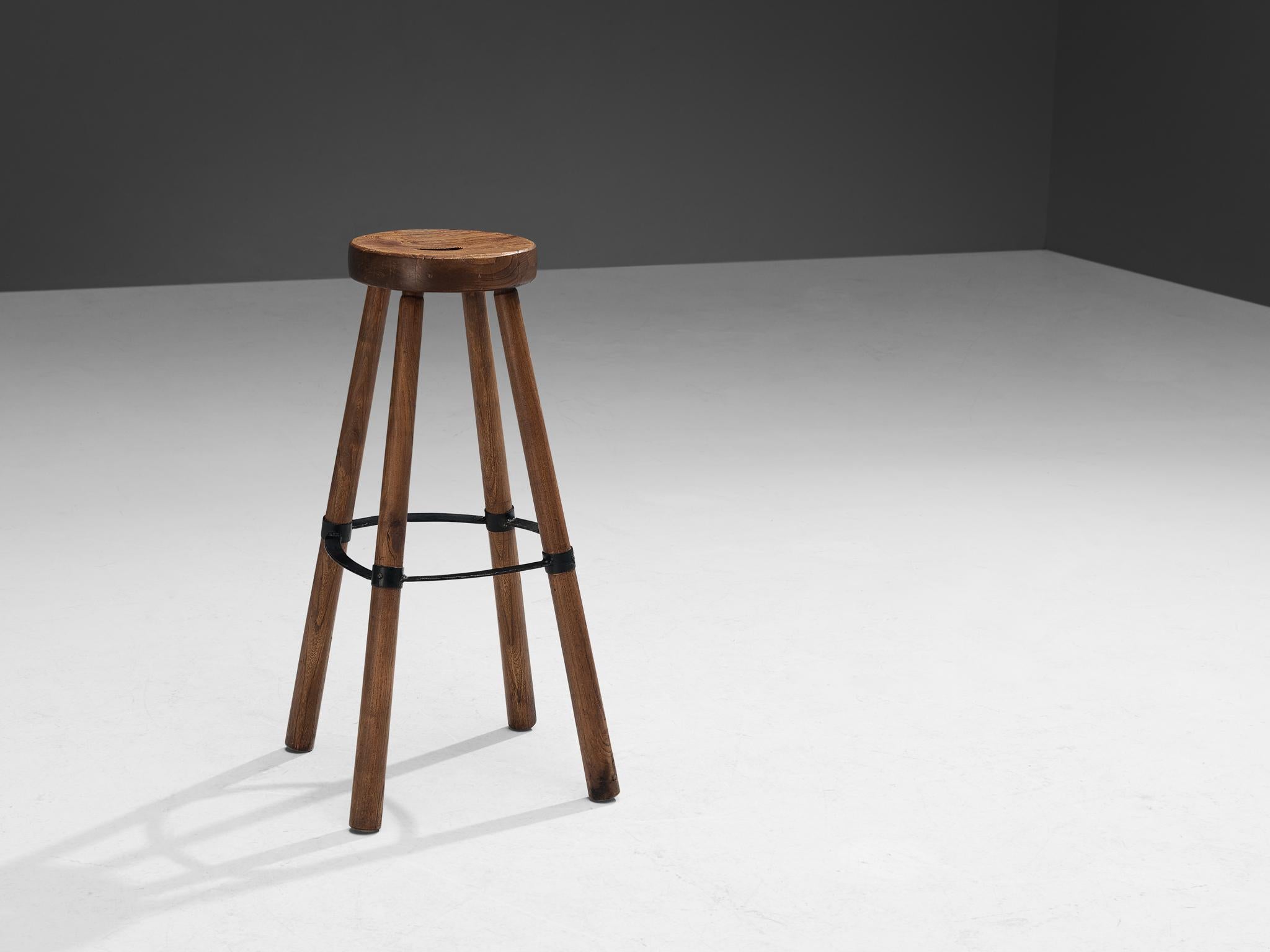 Bar stool, metal, beech, France, 1960s.

Sturdy stool in beech with a great patina and metal ring around the crux of the stool. This piece strongly reminds of the furniture produced by 'Les Artisans de Marolles' in the 1950s and 1960s. A