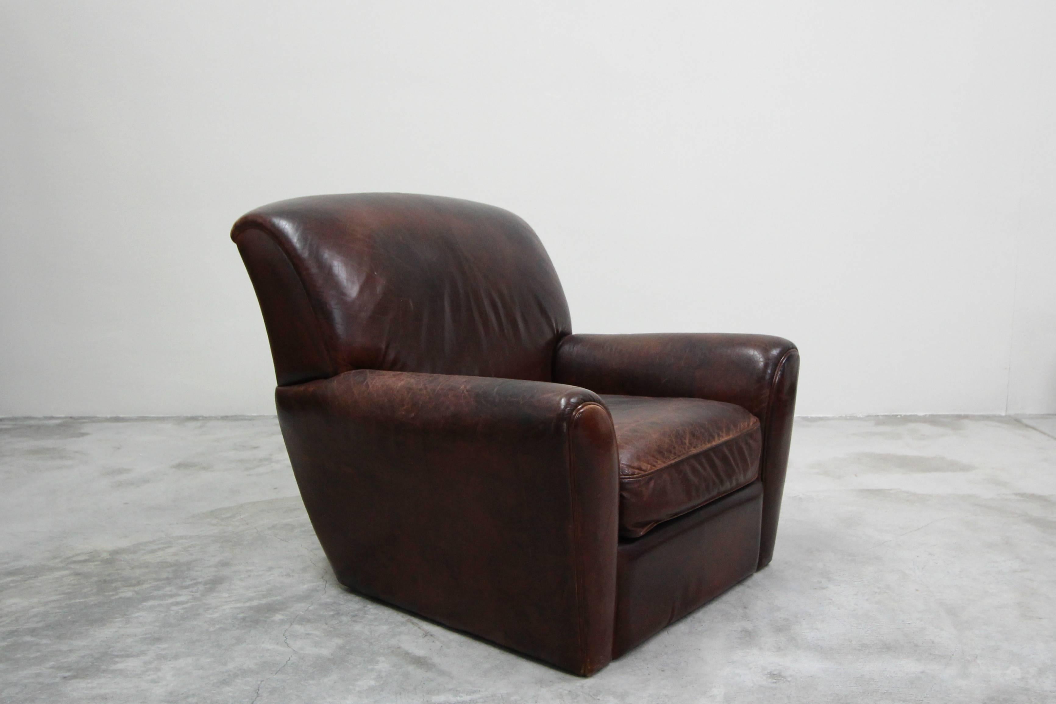 This is the ultimate vintage leather club chair. This French style patinated leather club chair is the epitome of perfect worn leather chairs. This chair features the kind of patina that money can't buy, the kind that only comes with use over the