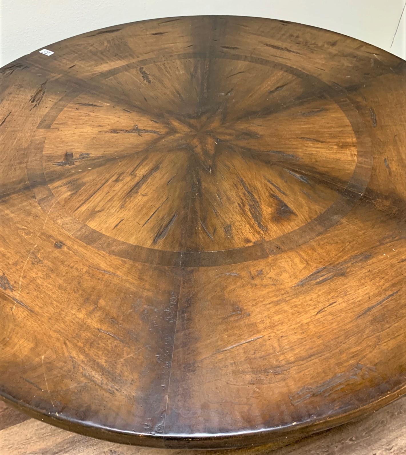 Excellent quality custom made French style walnut and alderwood center-of-the-room or breakfast table featuring a decorated circular top raised on a turned baluster and stepped plinth. Finely crafted possessing rich color and a warm patina.