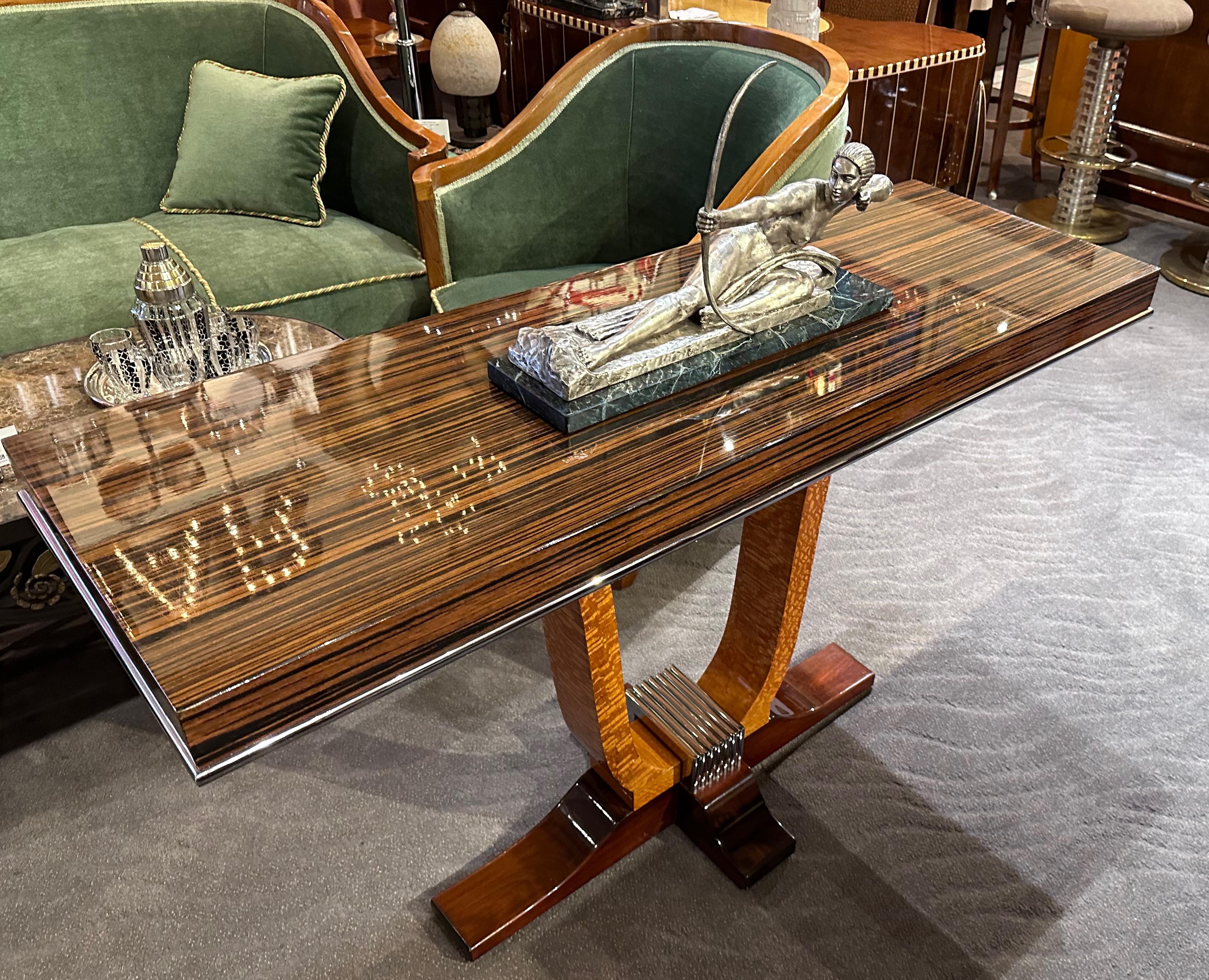 French Style Art Deco Console Macassar & Chrome. This elegant console was made in Argentina and is crafted in Macassar, satinwood, and black lacquered wood. The piece is accented with chrome detailing along the table edge and at the base. This