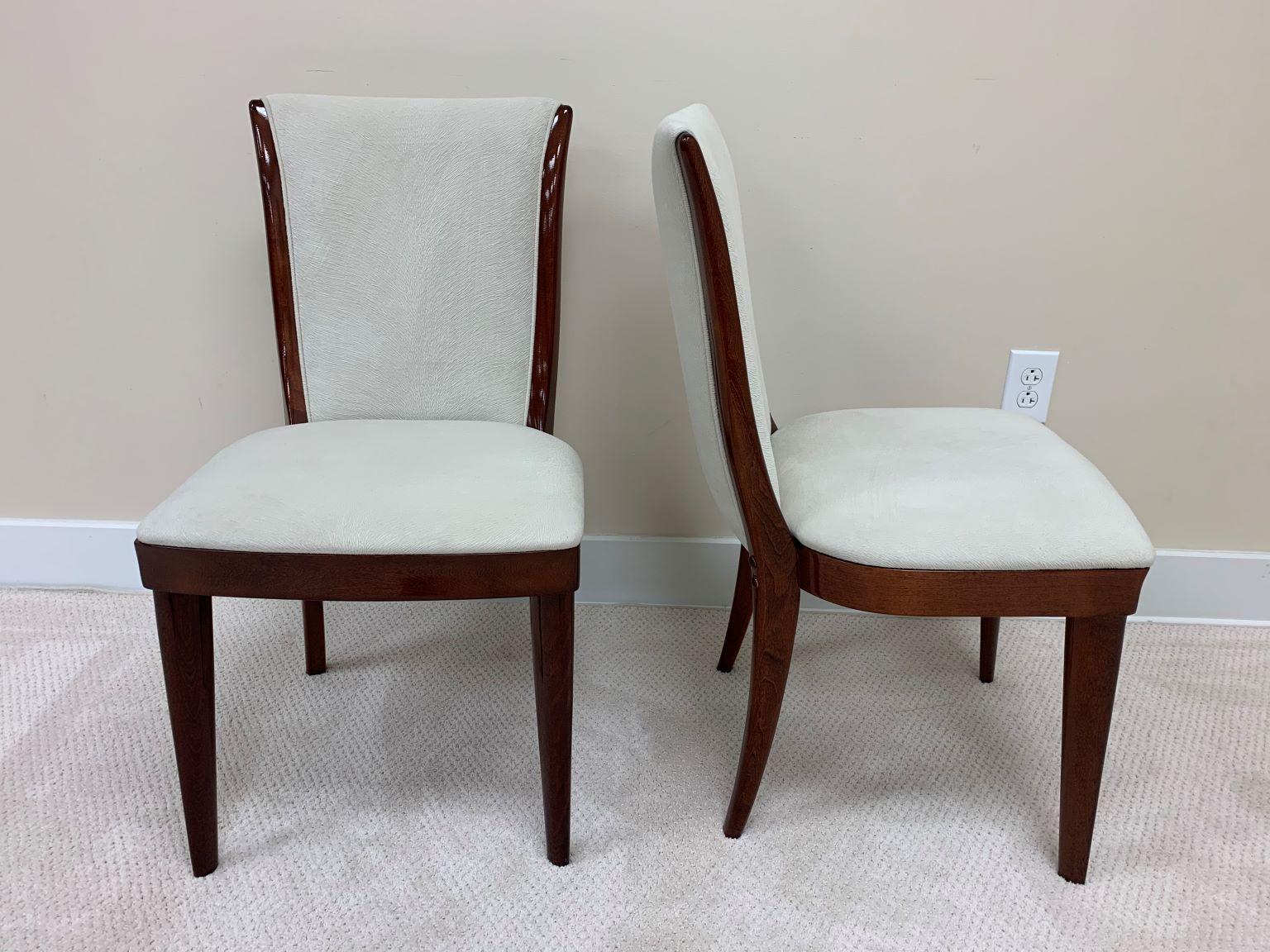 Set of six French style Art Deco streamline armless dining chairs. A very simple and elegant streamline design. The solid maple stained frames have been beautifully restored and the upholstery redone in off white faux pony skin. Dimensions: 33