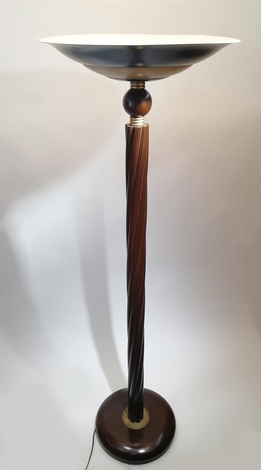 This is a unique French Art Deco floor lamp in beautiful brown wood shaft design with a superb lighter color wooden rings decoration, a circular base and brass torchiere.
A dimmer is connected to the light fixture to lower the brightness of light.