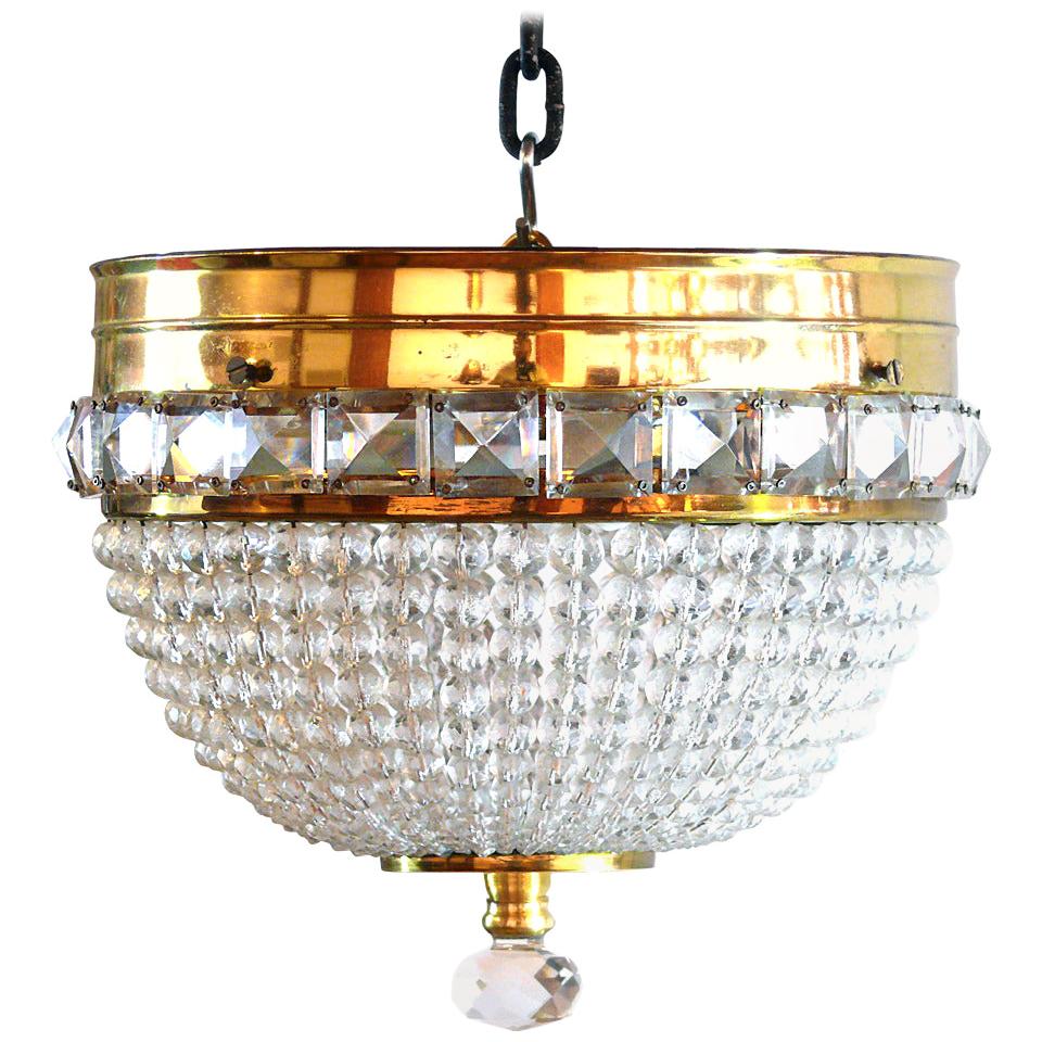 Hollywood Regency French style brass flush mount chandelier with beaded crystals with two sockets.