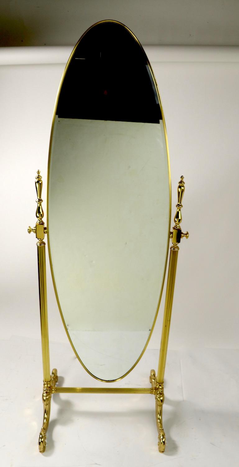 Incredible brass frame cheval mirror by noted manufacturer J. B. Ross having an oval mirror supported by cast brass frame. The interior bevelled mirror measures 63 inch H x 20 inch W.
The mirror is in exceptional condition, free of chips, cracks or