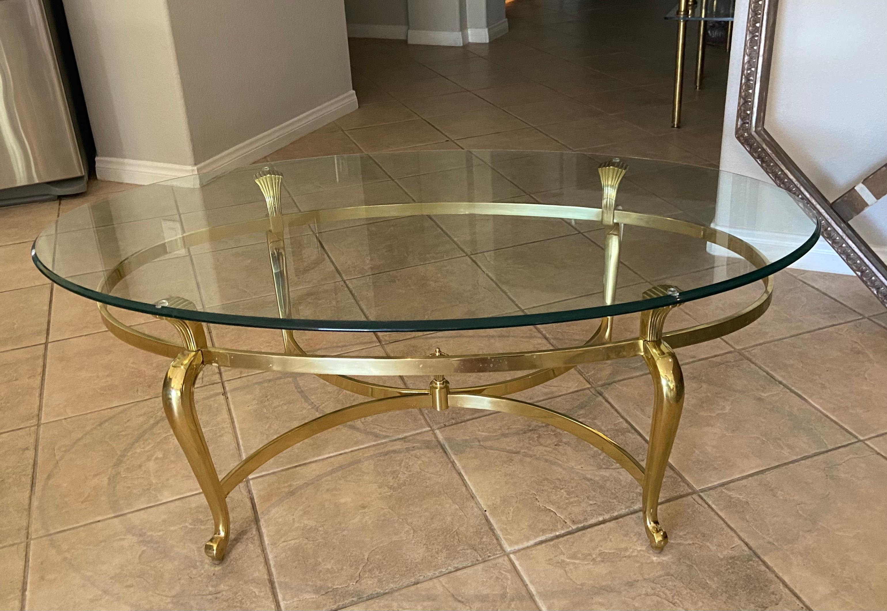 French style brass oval coffee or cocktail. Glass is thick with curved edge, frame is made of real brass (not plated) and is well made and nicely detailed. Great addition to both modern and tradition decor.