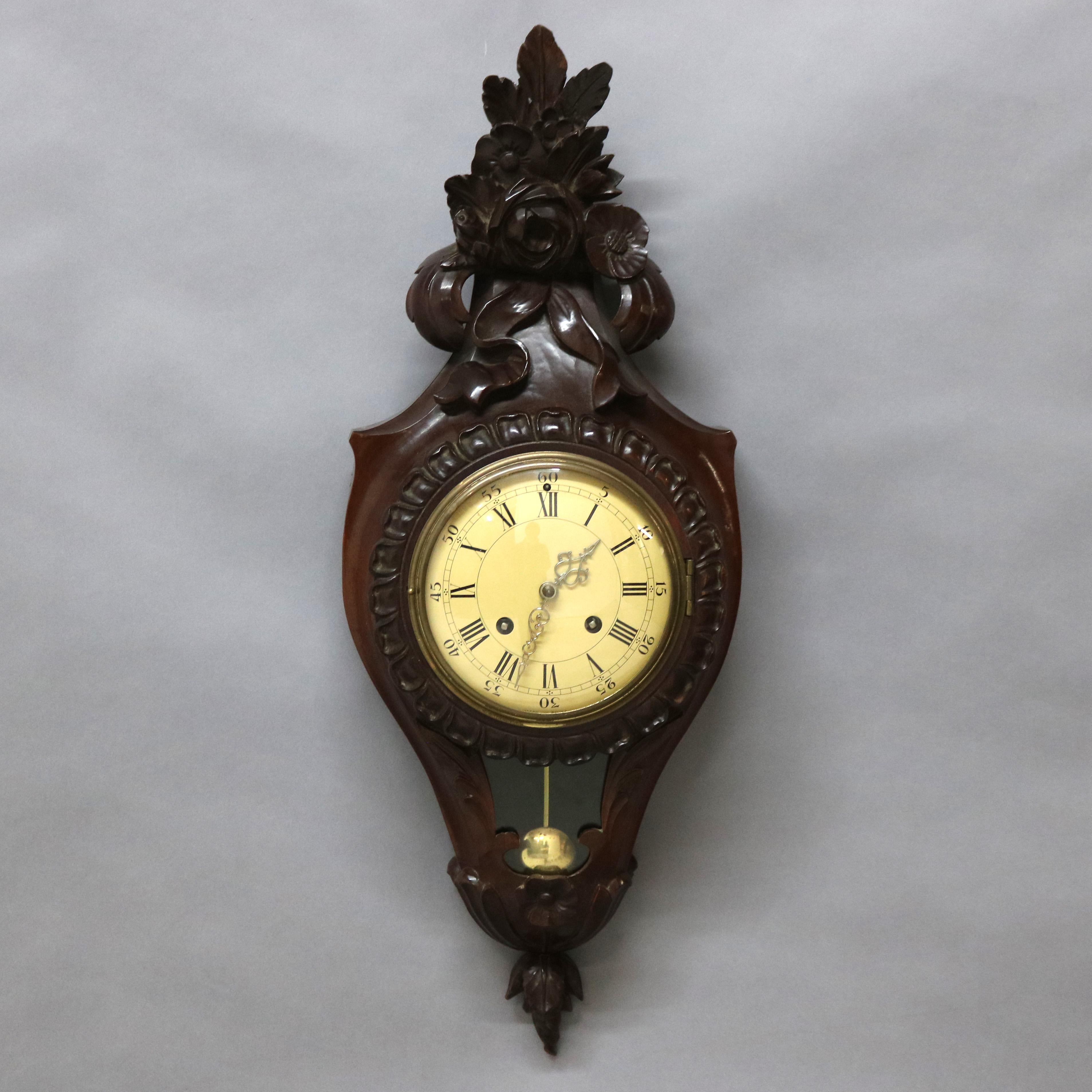 A French style Swiss 8-day wall clock offers carved mahogany case with floral elements, with key, 20th century

Measures - 28